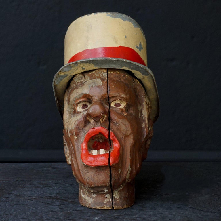 This head is from a fair or carnival game.
Not sure what the game was, perhaps the head has been used to toss rings over, or maybe you were supposed to throw something in his mouth. His hat does not come off, so it probably was not a Charlie's hat