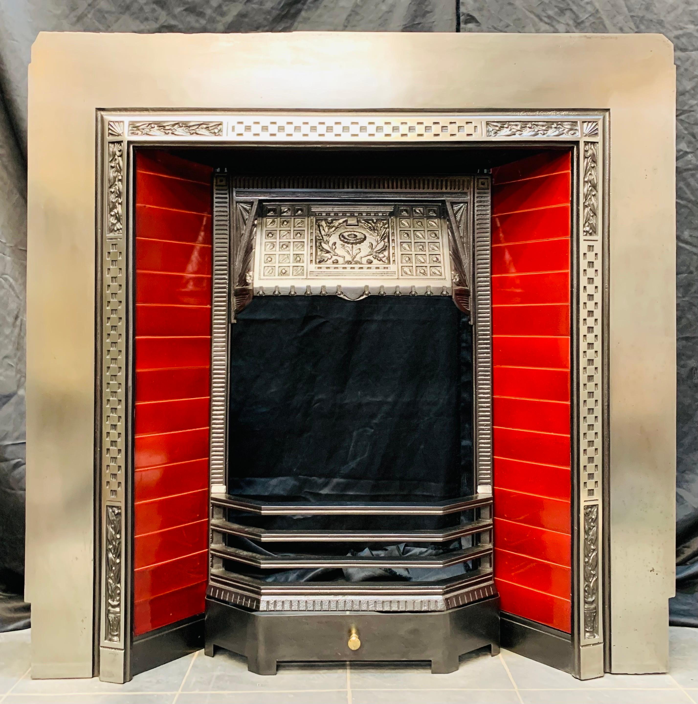 A bold and flamboyant 19th century Victorian cast iron fireplace insert by the renowned foundry Carron of Falkirk. A polished outer plate with a raised cast framed border. The returning rectangular tiles in the shade of Victorian dinning room room