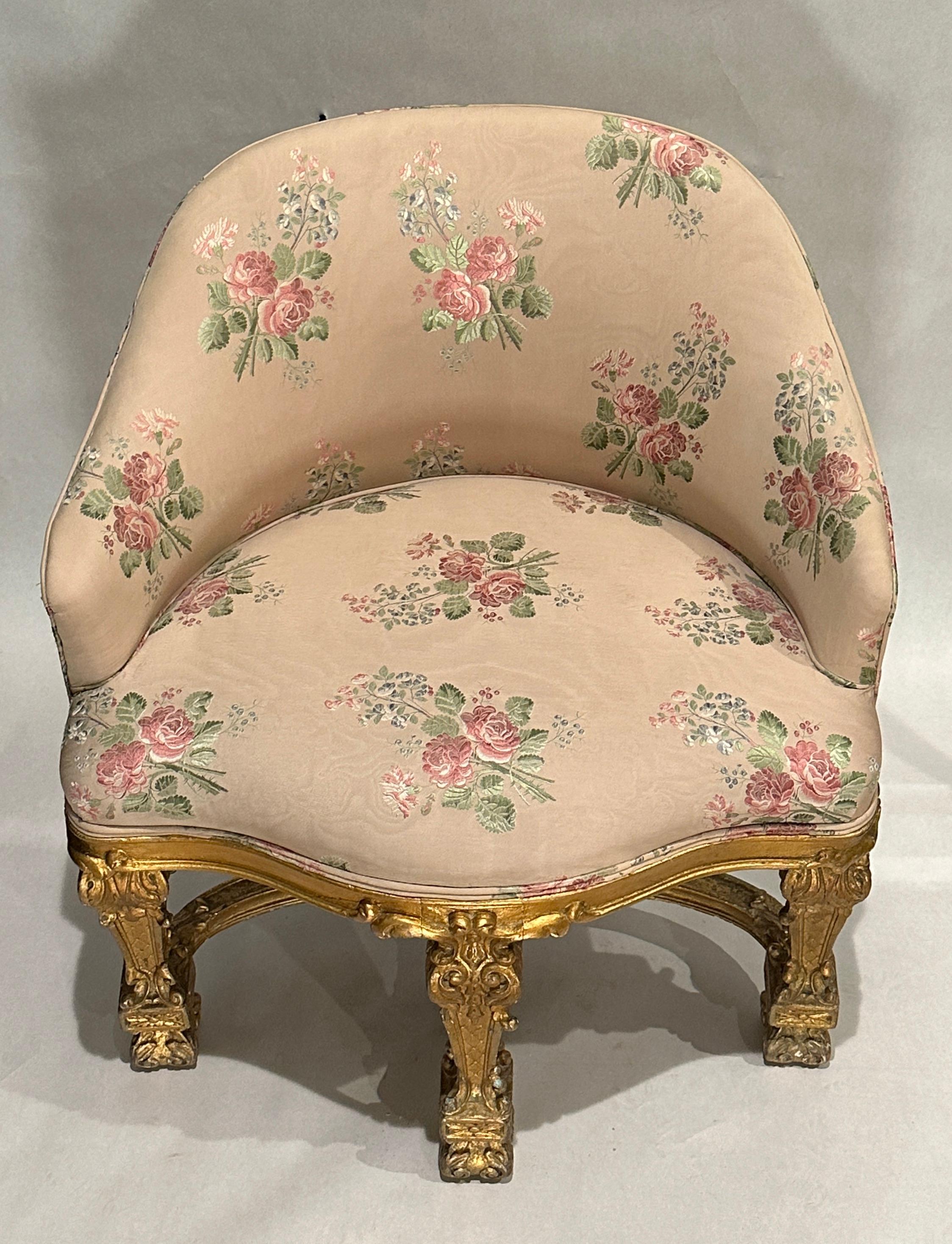 19th century French baroque carved and gilt vanity chair. Upholstered in a vintage fine and colorful brocade of roses and foliage. 