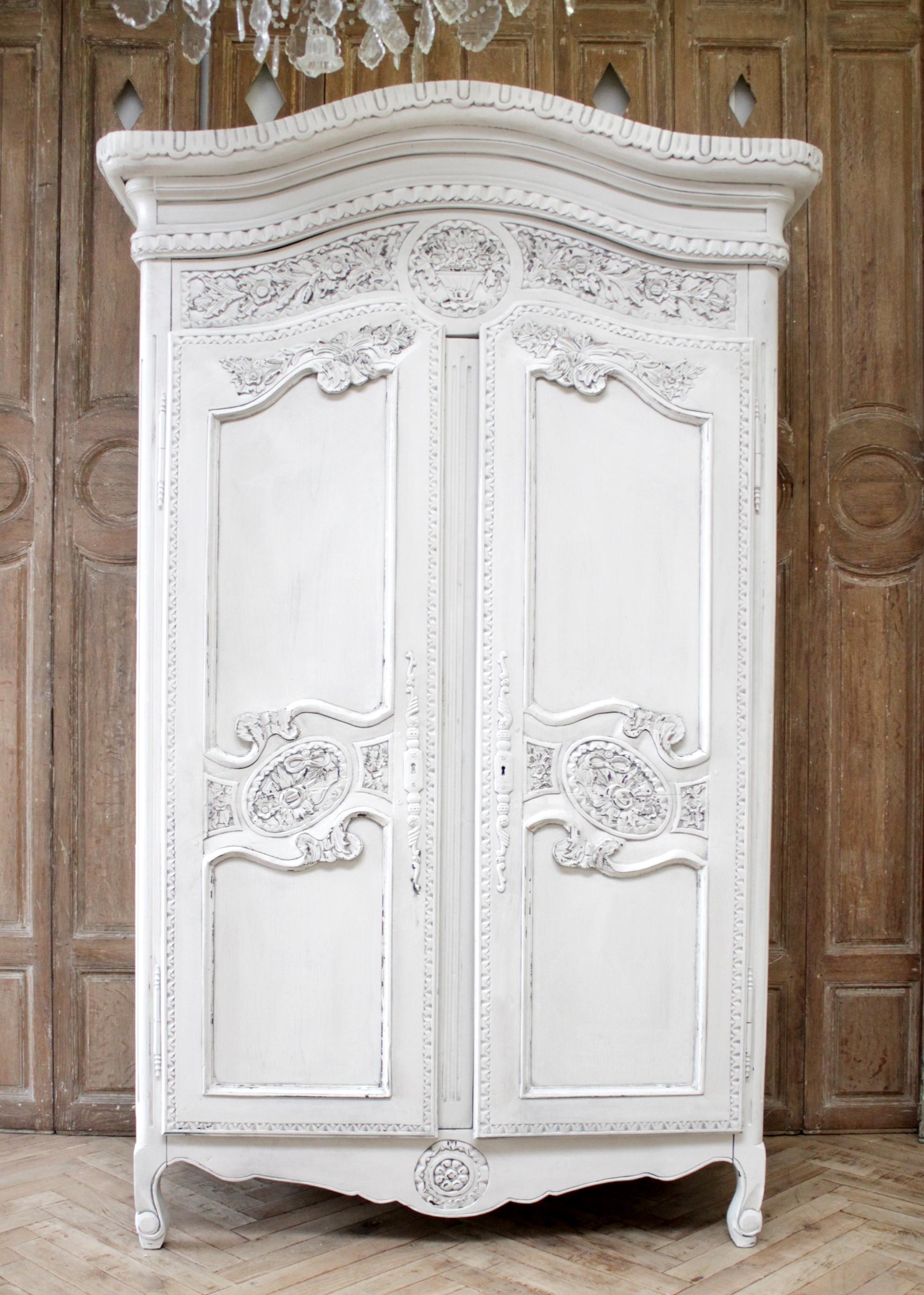 19th century carved and painted French armoire from Provence.
Painted in our oyster white finish, with subtle distressed edges, and antique patina.
Double doors open and close with ease, opening up to 3 shelves. 
Measures: 28