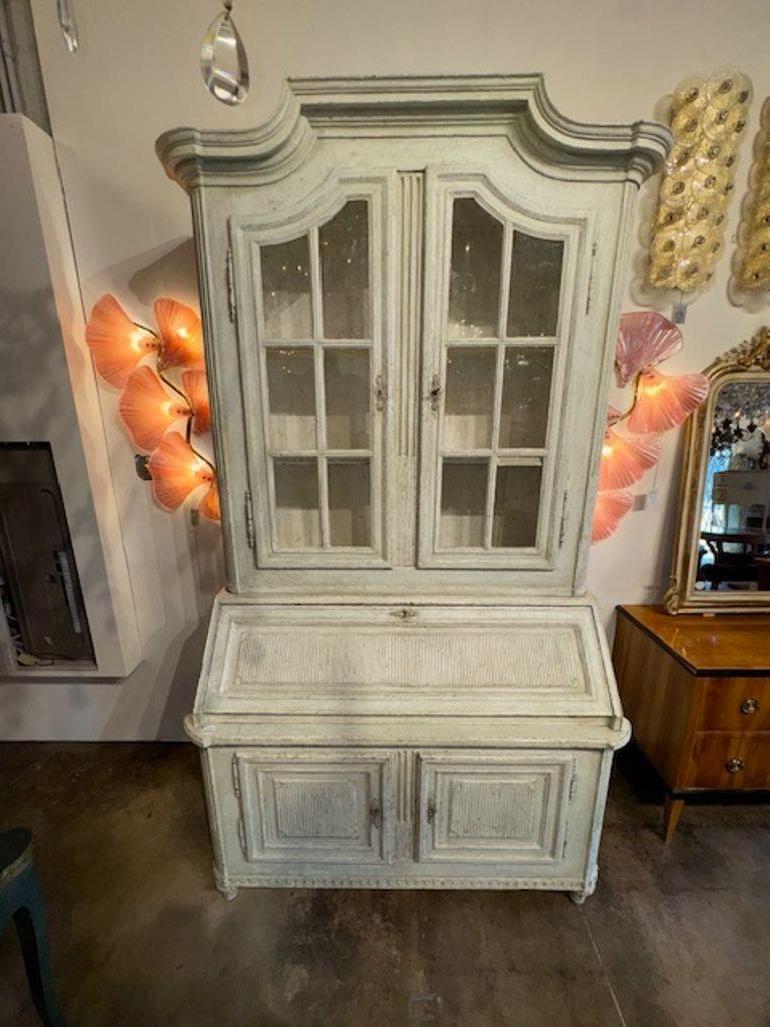 The 19th Century Carved and Painted French Oak Secretary is an antique piece of furniture that features painted oak and nice carvings. This elegant secretary desk showcases the craftsmanship and style of the 19th century, with its beautiful