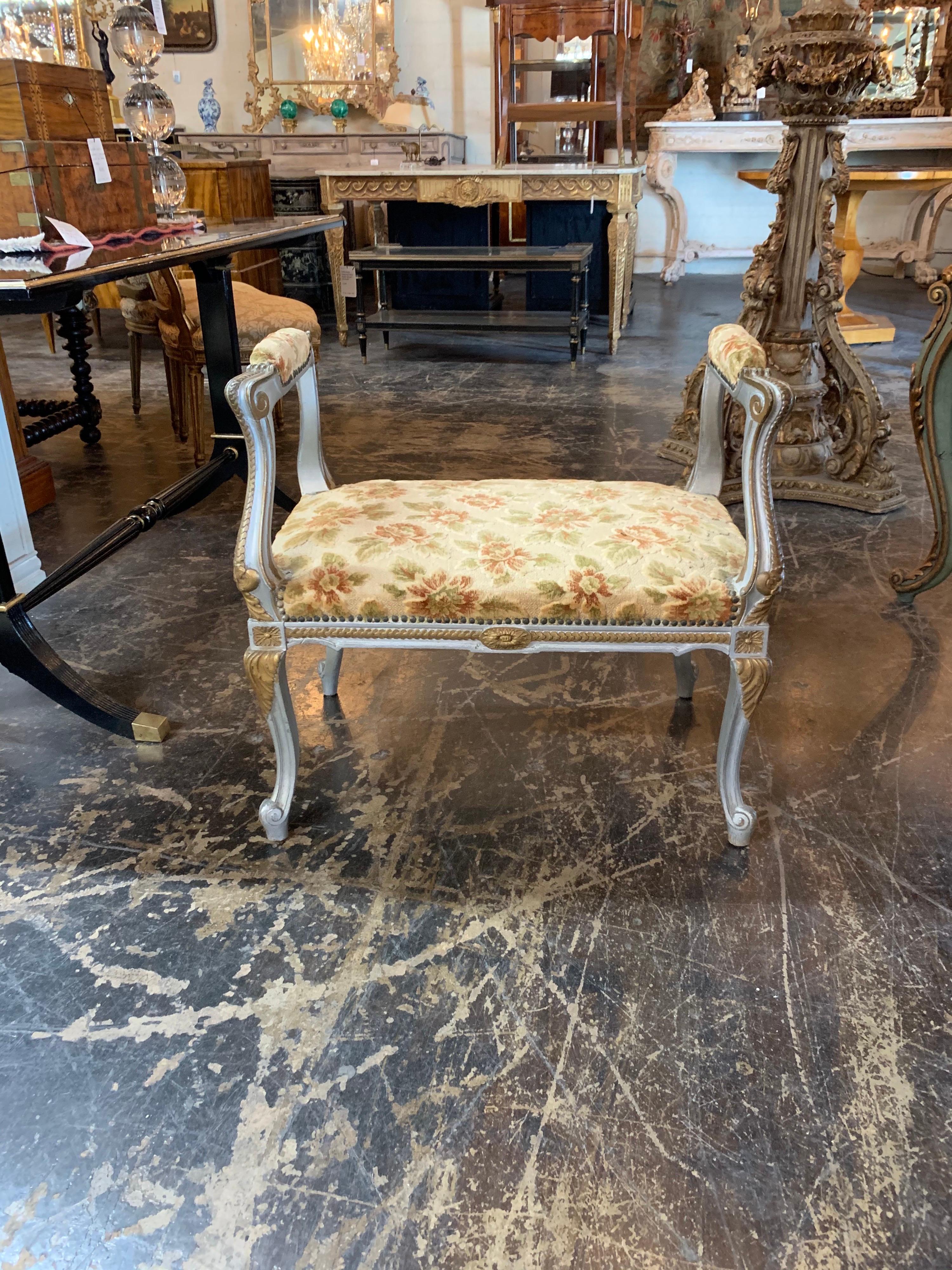 Elegant 19th century carved and parcel-gilt Louis XVI style window bench. Beautiful carved details on the wood and upholstered in a lovely floral fabric. This piece would be great in a ladies dressing room. So pretty!