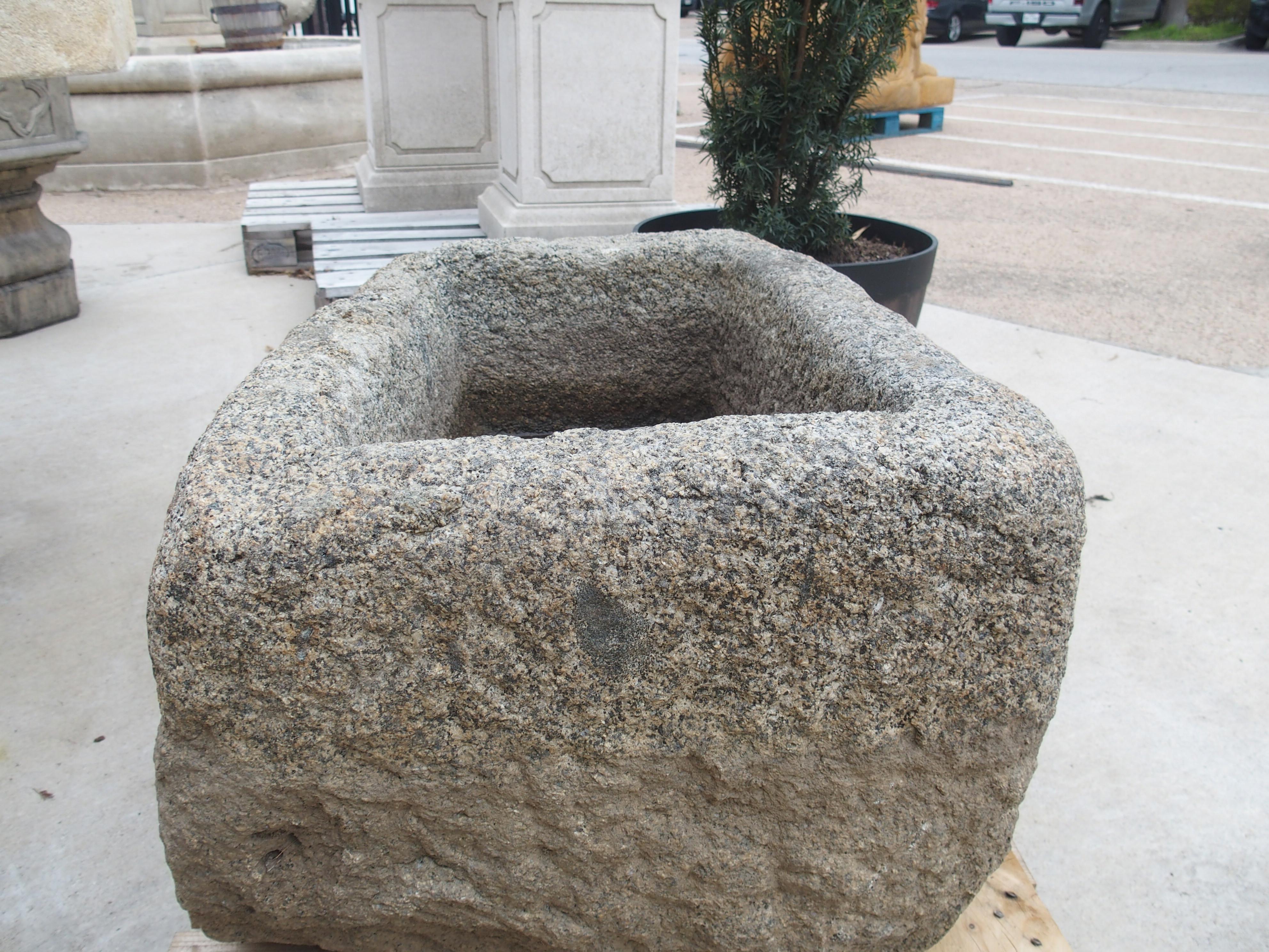 Hand-carved in Brittany, France, during the 1800’s, this weathered granite trough has a beautiful, speckled appearance as the result of inclusions and a centuries old patina. There is a demarcation line of color, indicating that the trough was