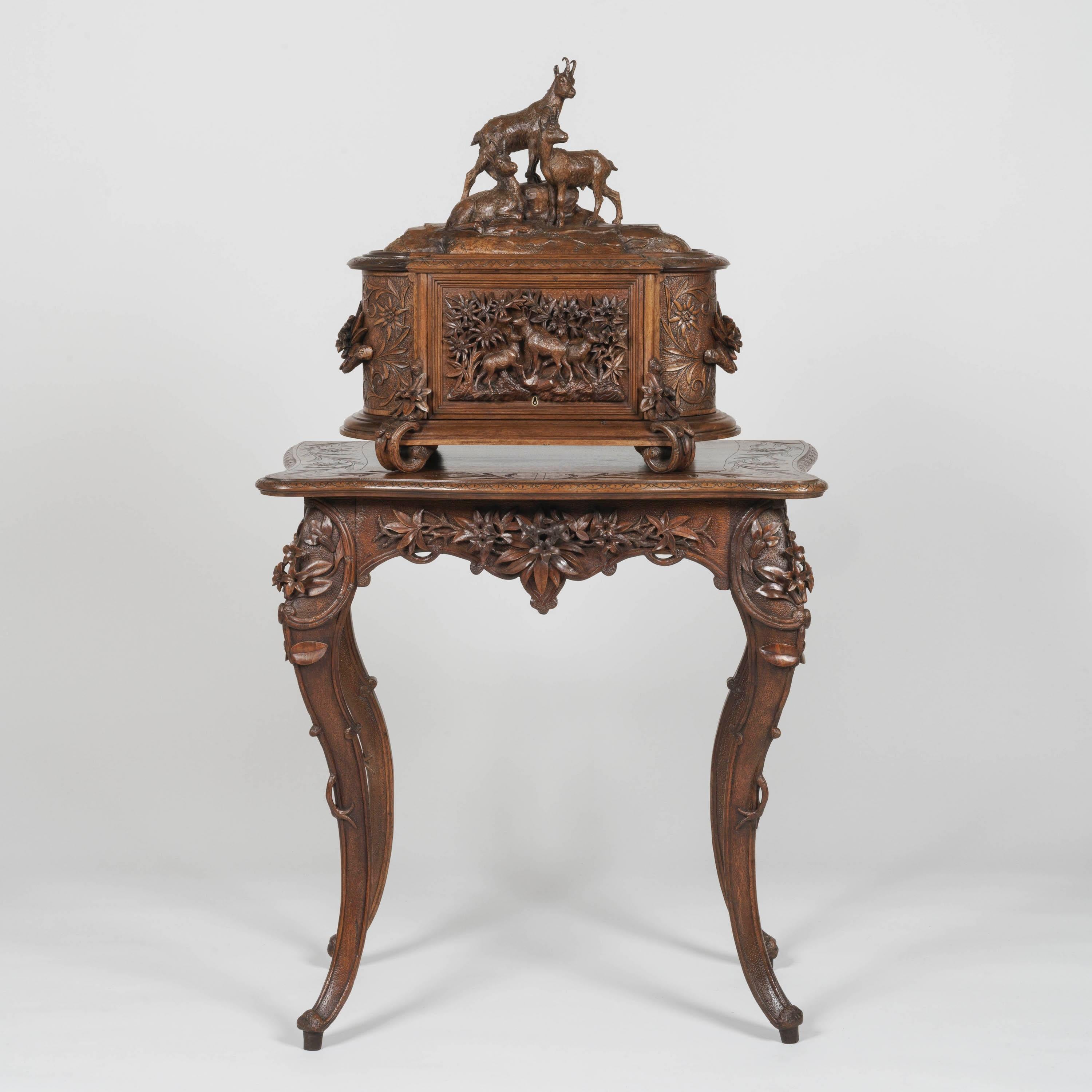 A magnificent 'Black Forest' carved
Drinks cabinet on stand

Hand-carved from Lindenwood, the drinks box of D-end shape carved in exquisite high relief, the front panel depicting a flock of goats surrounded by tall wildflowers, the hinged sides