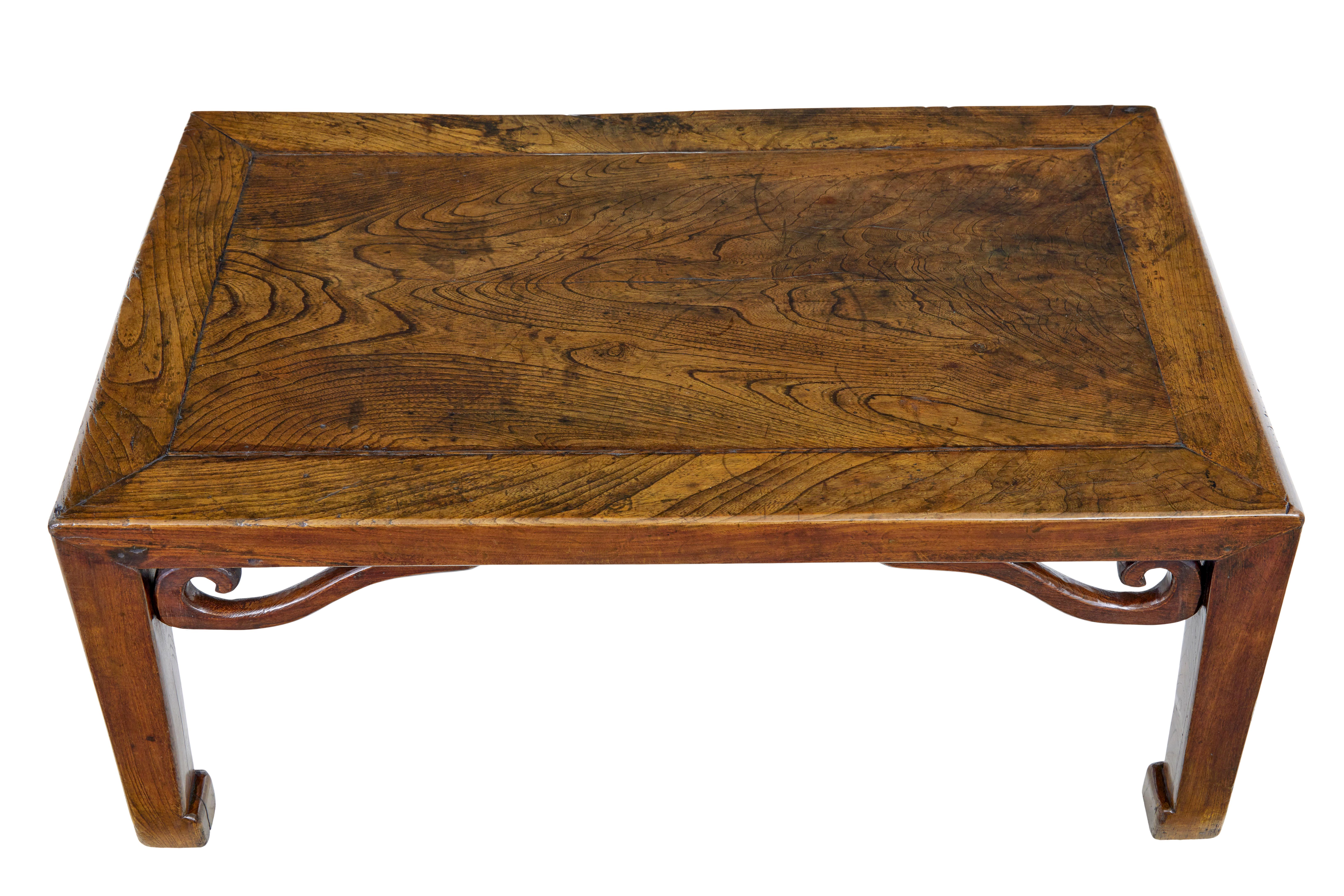 19th century carved Chinese elm low table circa 1850.

Good quality table which is made from stunning timber, showcasing it's grain and patination.  Rectangular top with a central single piece with surrounding border.  Raised on 4 legs with carved