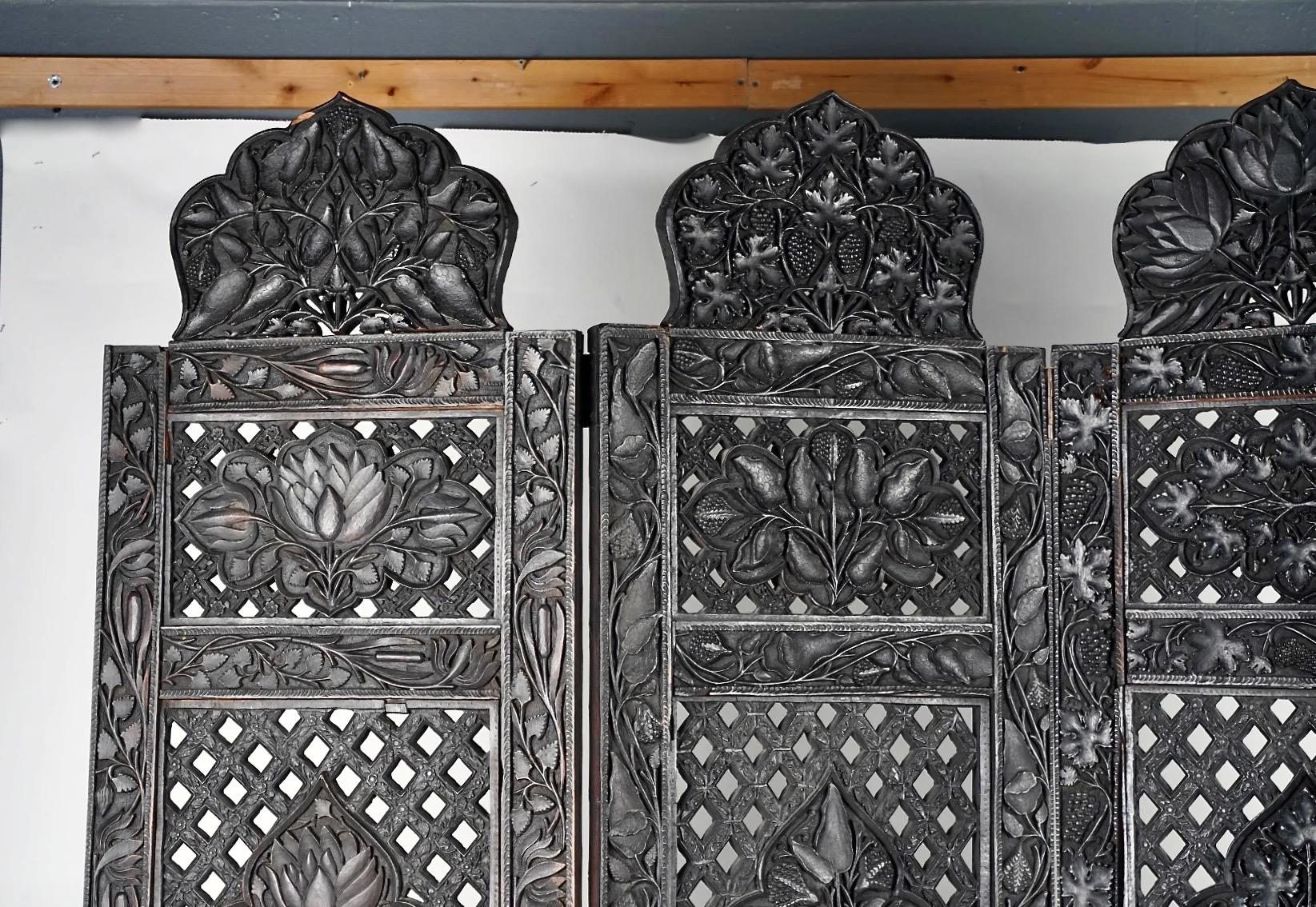Il s'agit d'un paravent en bois dur indien Anglo-Raj finement sculpté, datant de la fin du XIXe siècle, qui a été fabriqué pour le marché de l'exportation. L'écran à quatre panneaux présente quatre panneaux floraux sculptés distinctement à l'avant
