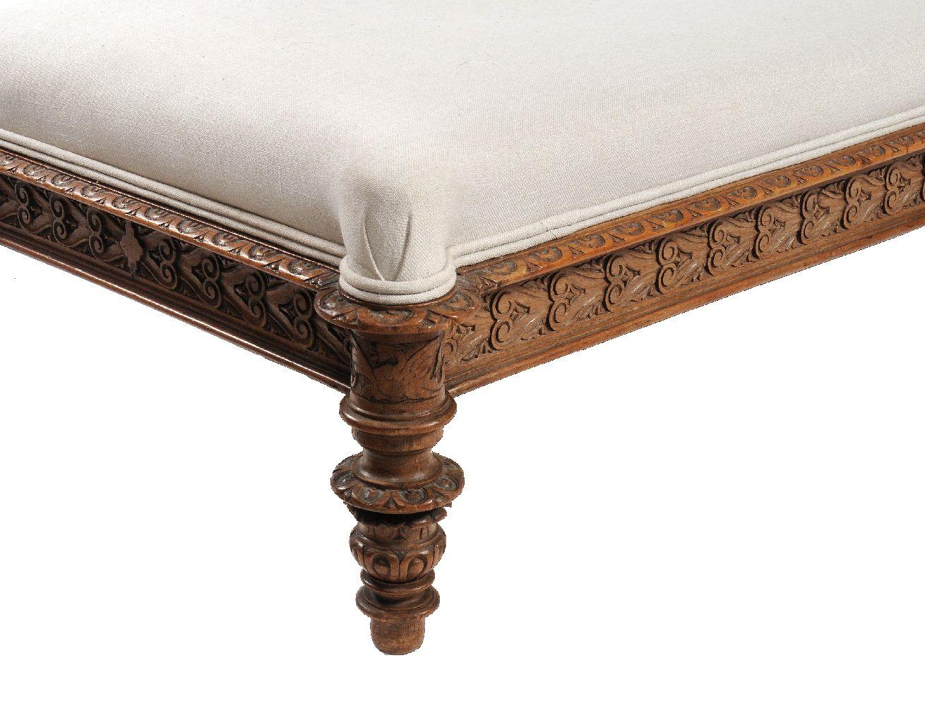 A beautifully detailed Continental carved walnut daybed in Renaissance Revival taste from the late 19th century. Having a nicely detailed pair of carved putto looking across at each other. The rectangular seat above a molded and scroll carved