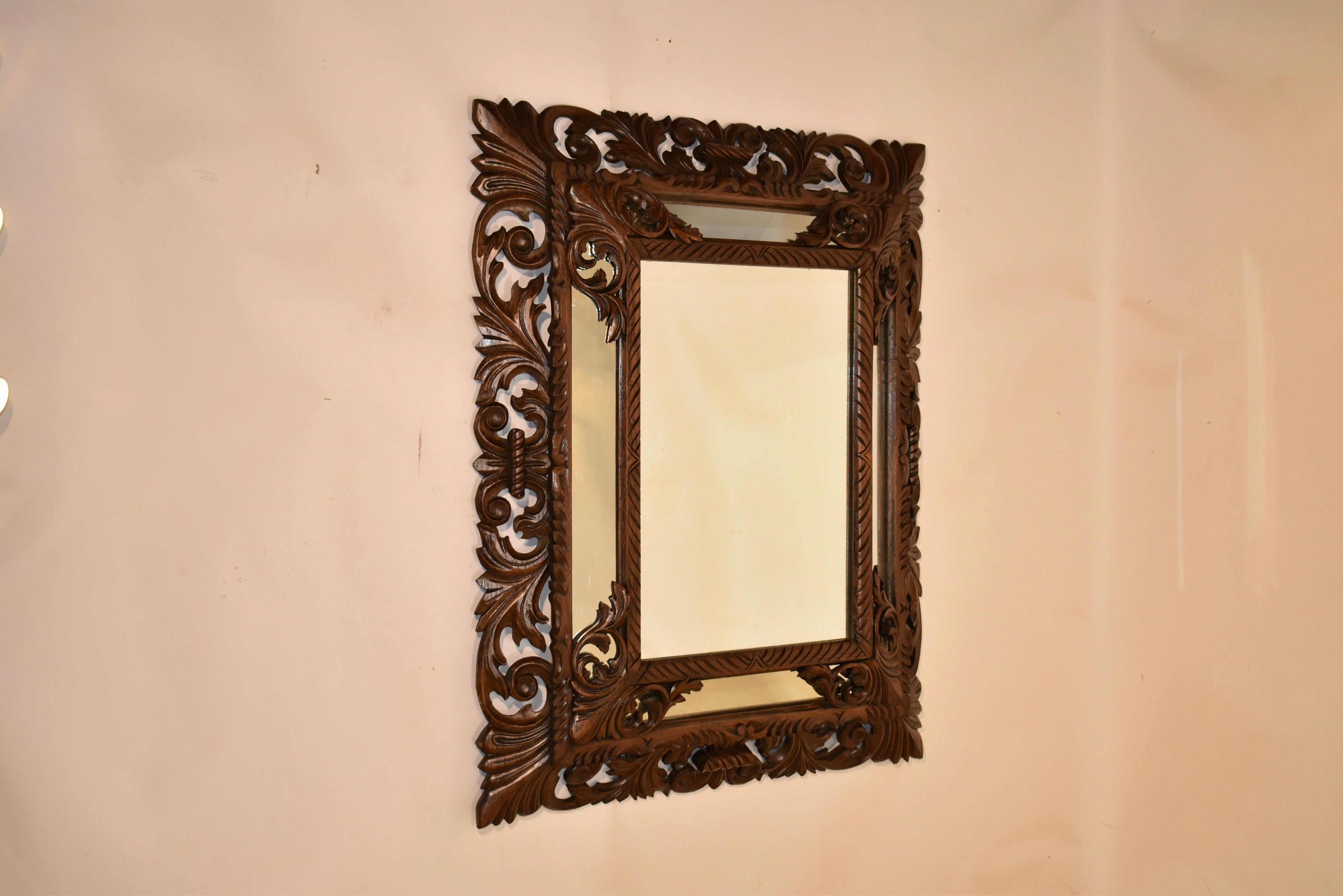 19th century wonderfully hand carved cushion mirror which came out of the grand house Locksley Hall in Staffordshire.  The outer frame is hand carved and has a glorious pattern of leaves and scrolls.  The inner frame is also hand carved with joining