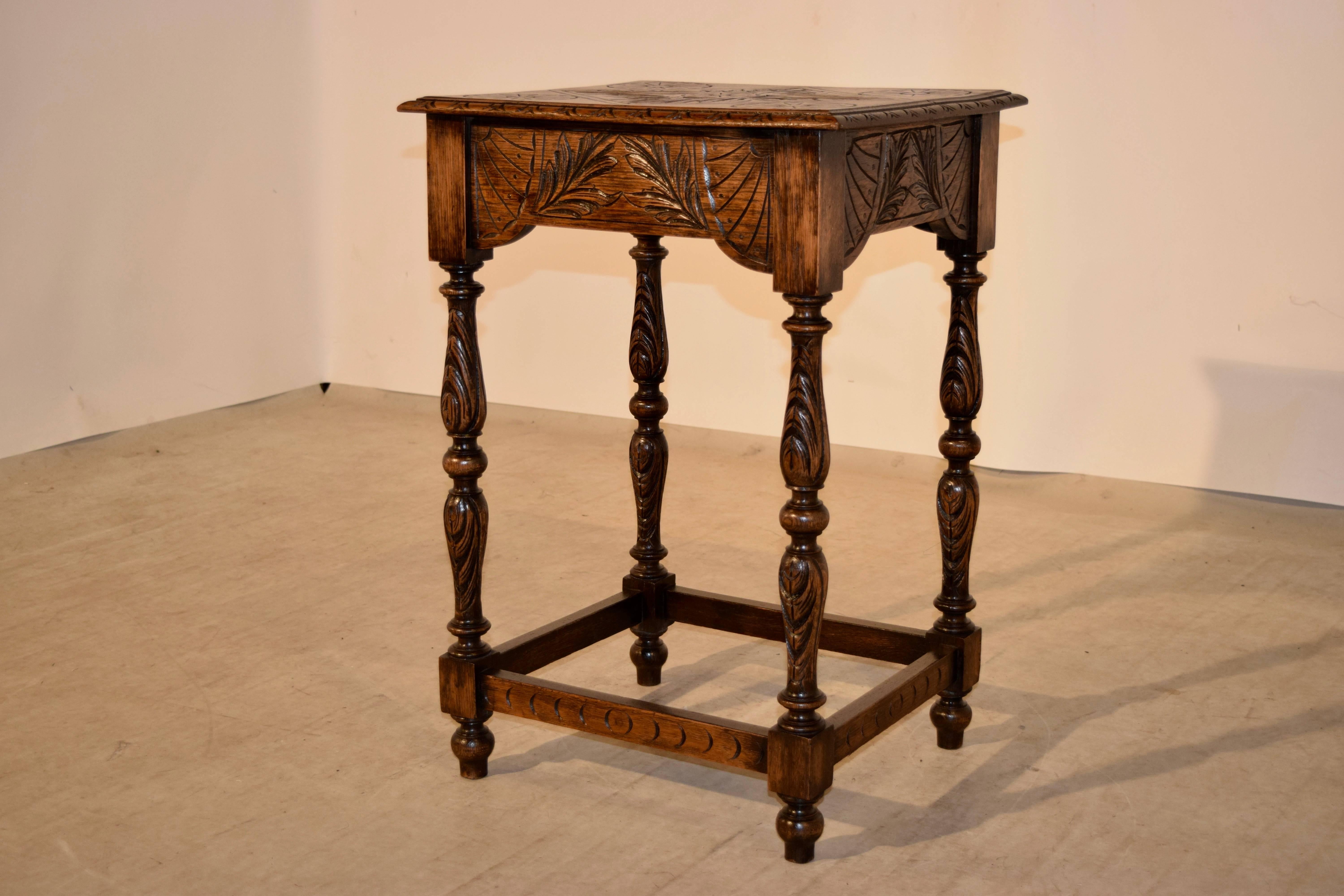 19th century carved oak side table from England. The top is wonderfully hand-carved and has a beveled edge which is also carved decorated. The apron is carved on all four sides for easy placement in a room. The carvings are of fan and leaf designs.