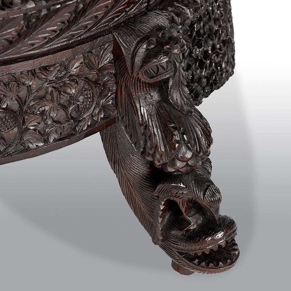 A 19th century carved filigreed Burmese chair of large proportions, with exceptional carving.