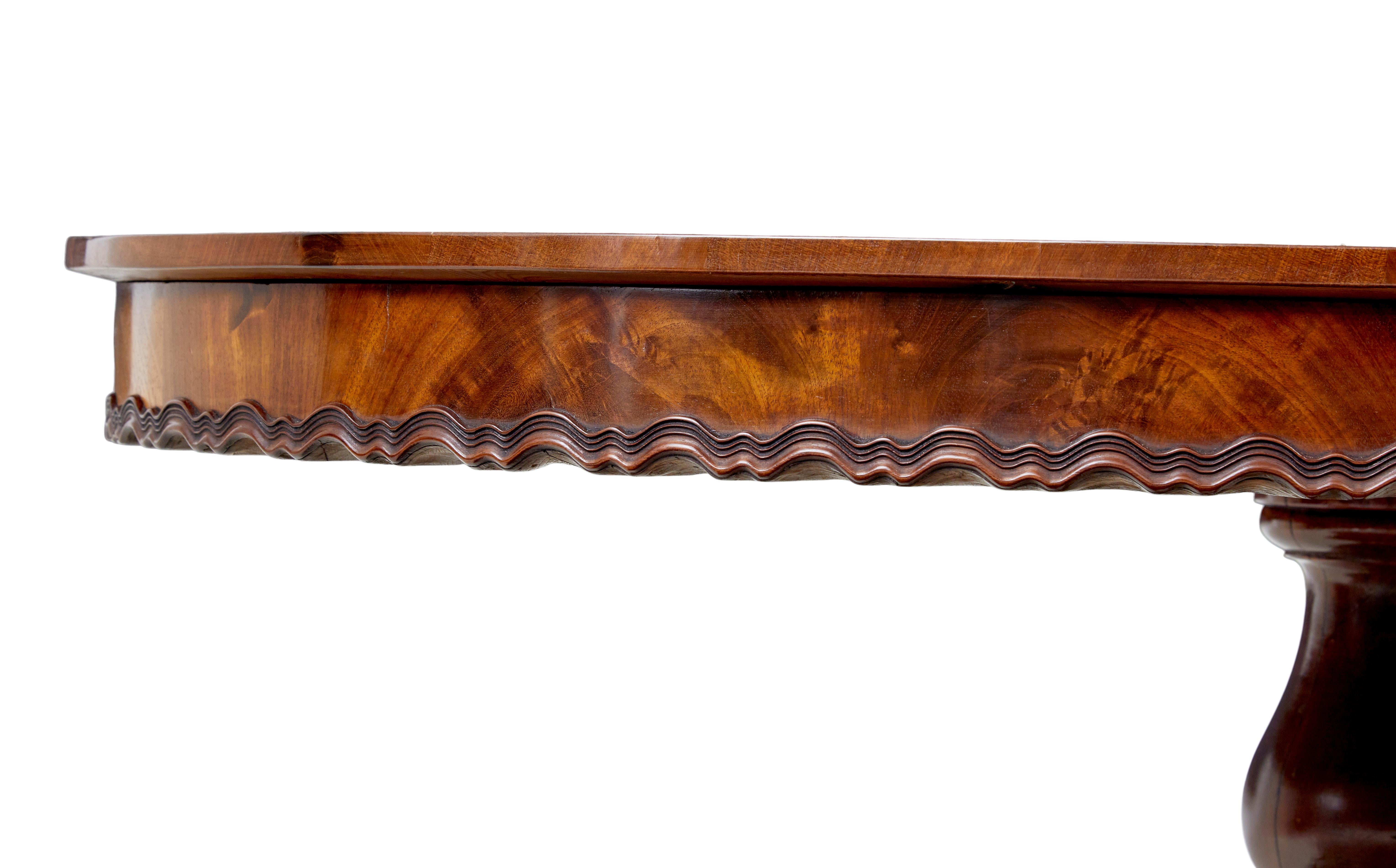 Swedish 19th Century carved flame mahogany oval center table For Sale
