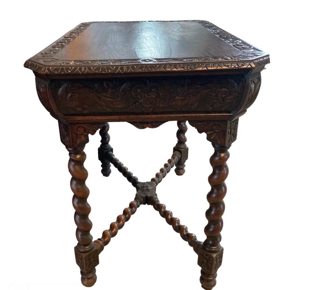 Side table hand-made and hand-carved in France in the mid 1800s using oak. The table has a lot packed in a small footprint while maintaining elegant lines and appearance. The top is composed of a single board with slanted corners (making it look