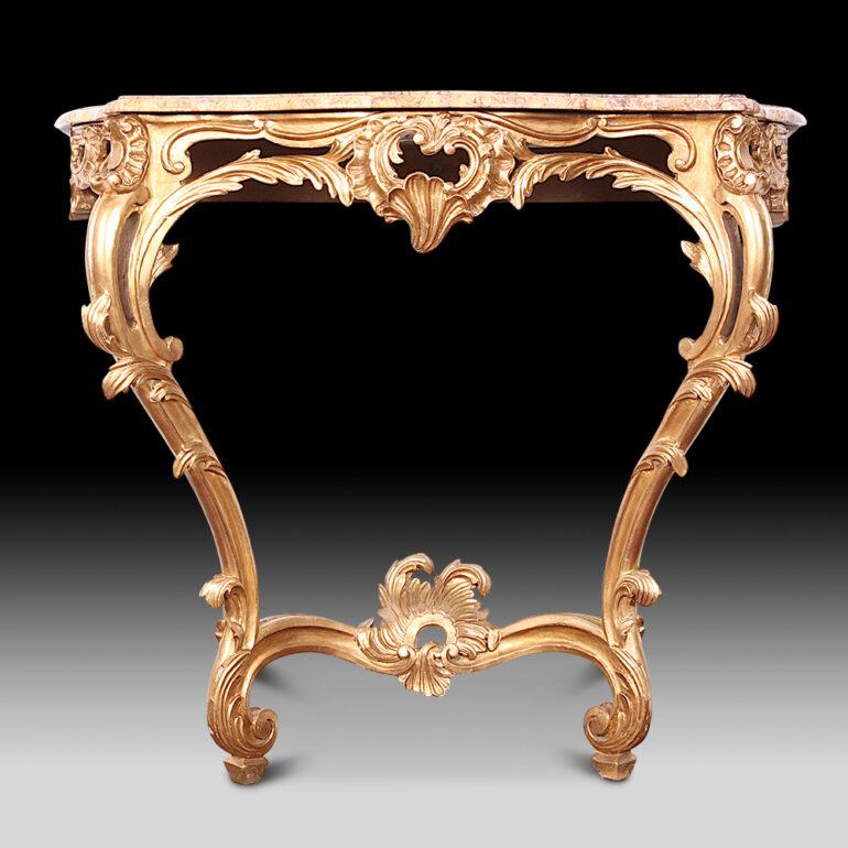 An ornate French 19th century gilt carved Louis XV style wall-mount console featuring pierce-carved cabriole legs and apron and raised on carved scroll feet. Original shaped marble top. C. 1880.