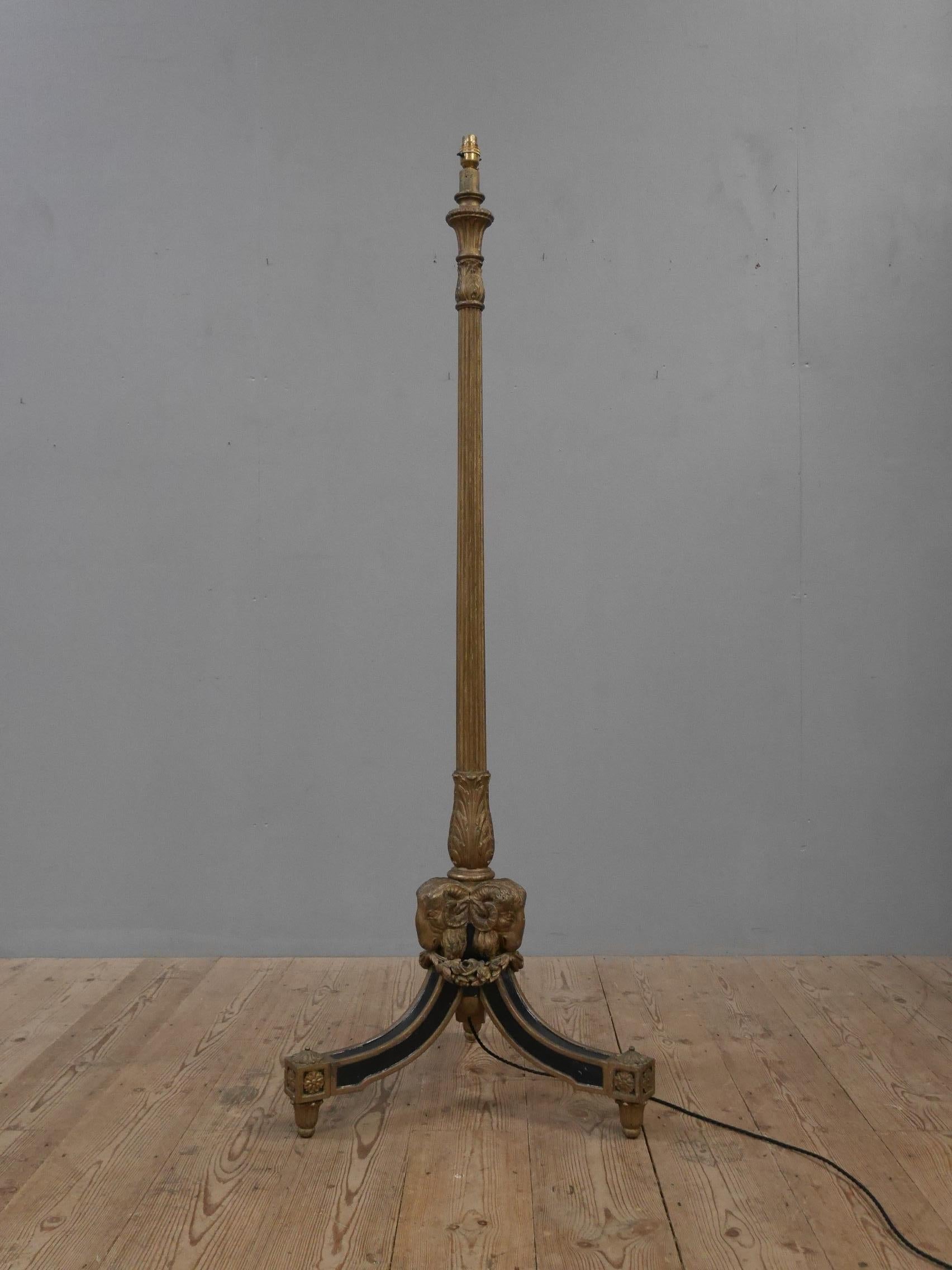 A beautiful & rare early English giltwood floor lamp.
A wonderful & striking piece of lighting in the Regency taste, raised on three sweeping, square legs with ebonised detailing supporting a tapered & reeded upright flanked by three beautifully
