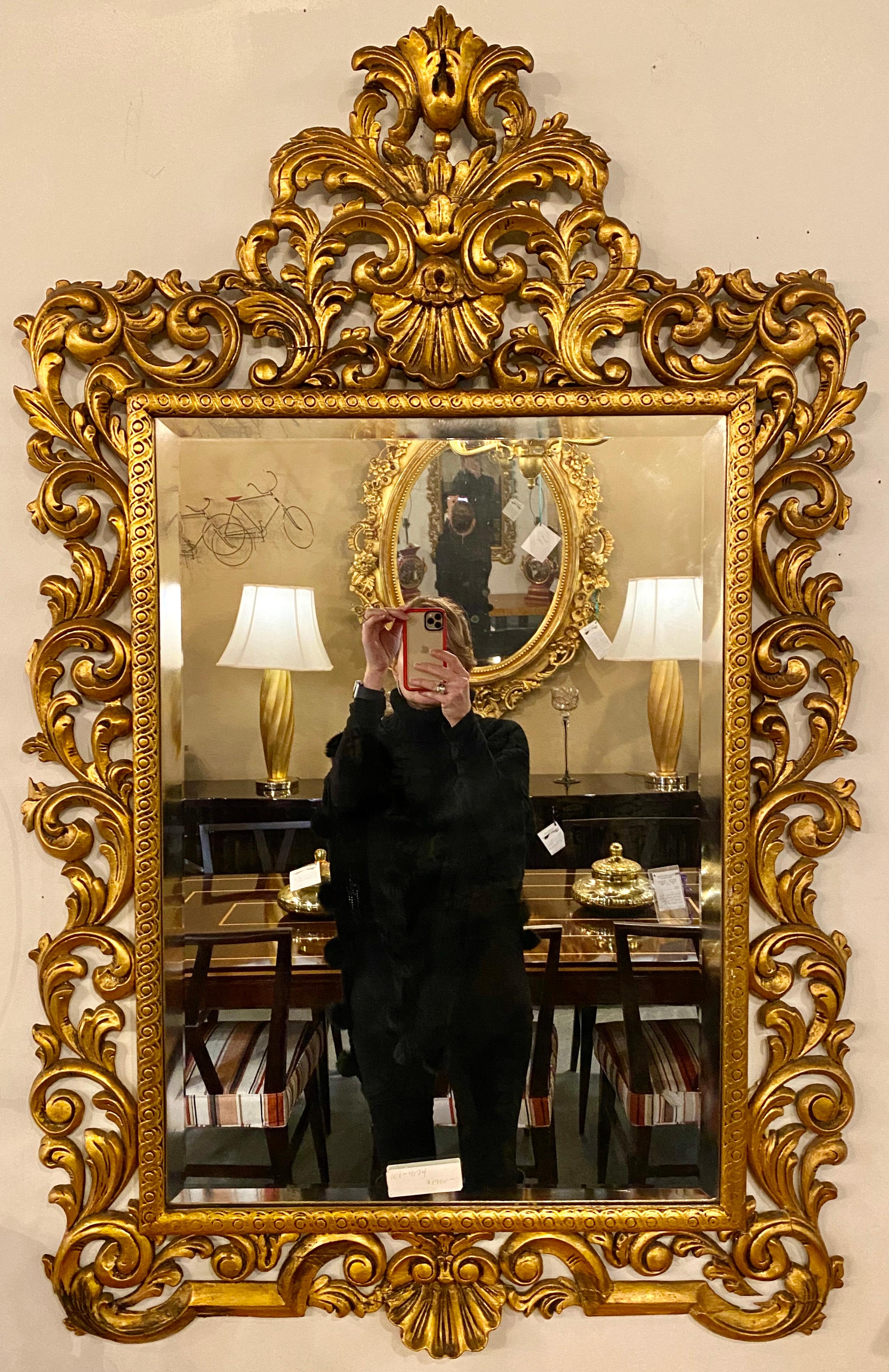 19th century carved giltwood beveled wall mirror. A finely carved giltwood wall mirror surrounding a beveled center mirror panel. Possibly Italian.