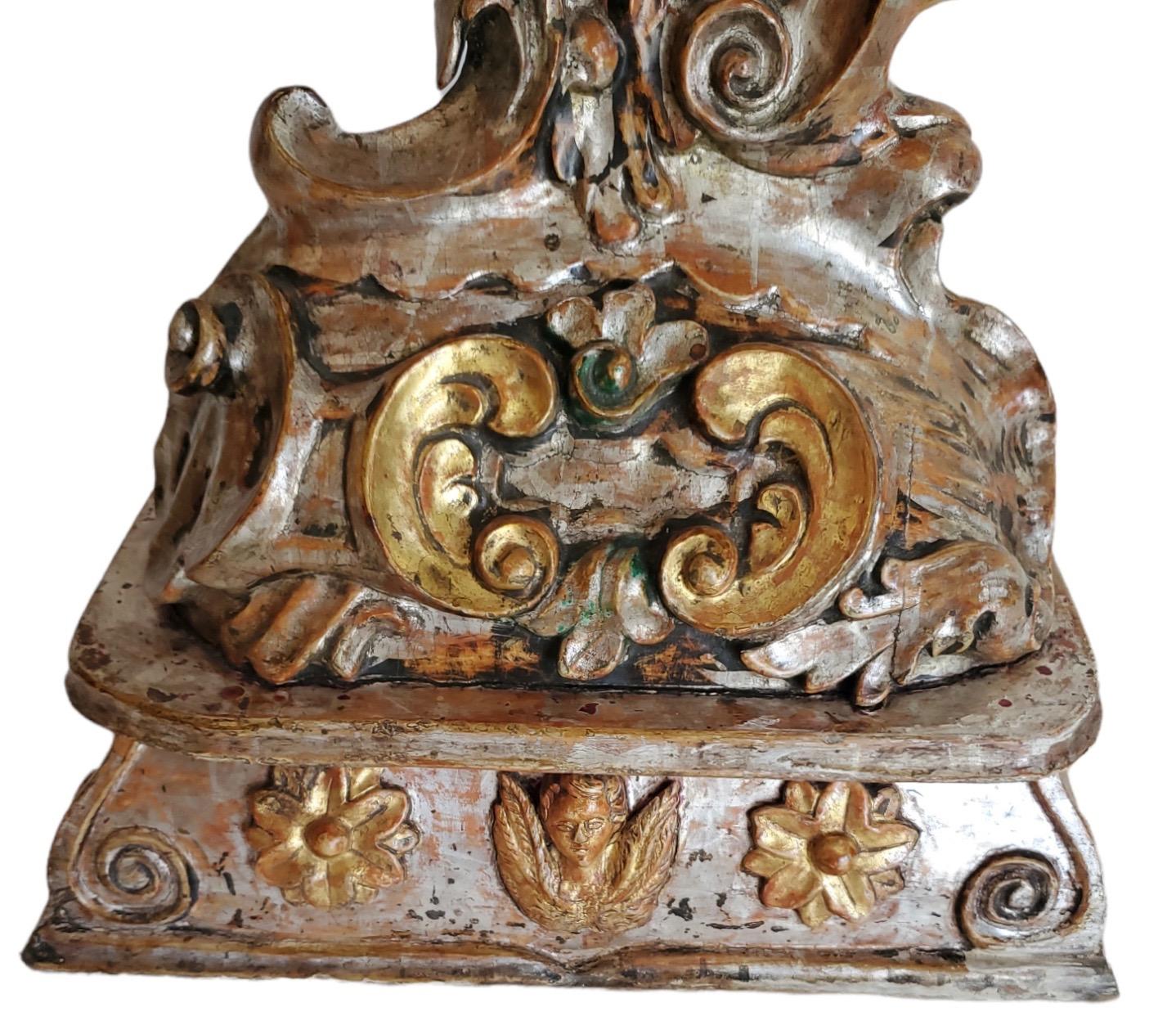 Finely carved and detailed with a mix of silver and gold leaf together.  Overall width is 18.5