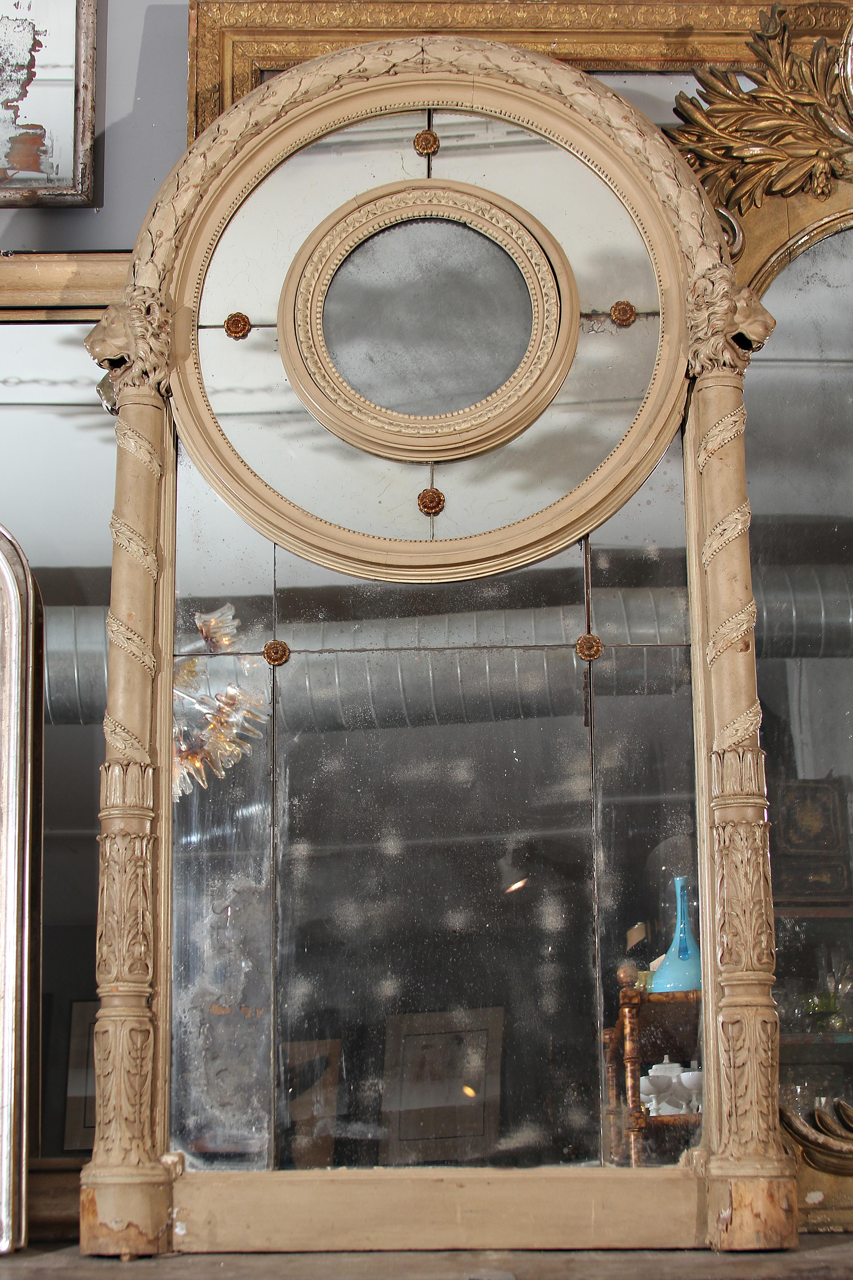 Grand 19th century Italian mirror in original paint with hand carved lions looking outward on each side. Beautiful patina to each mirrored panel.