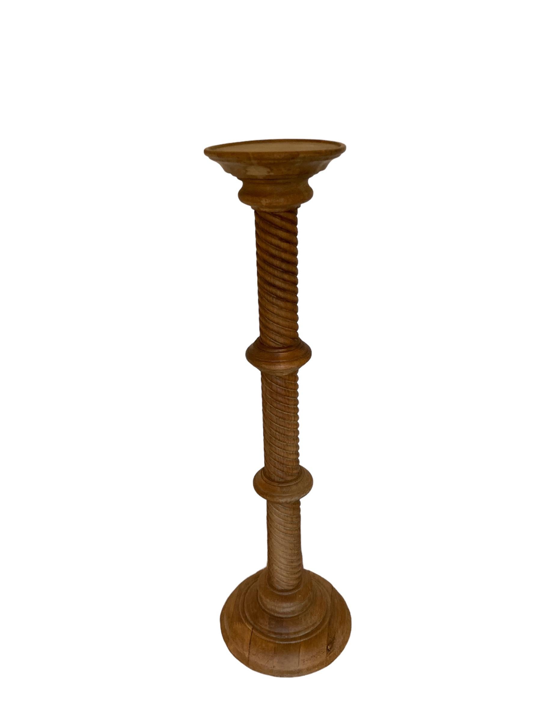 19th Century Carved light oak Pedestal Torchere with a captivating barley twist design. Crafted with precision and attention to detail, this exquisite piece adds a touch of sophistication to any space. Made from light Oak, its sturdy construction