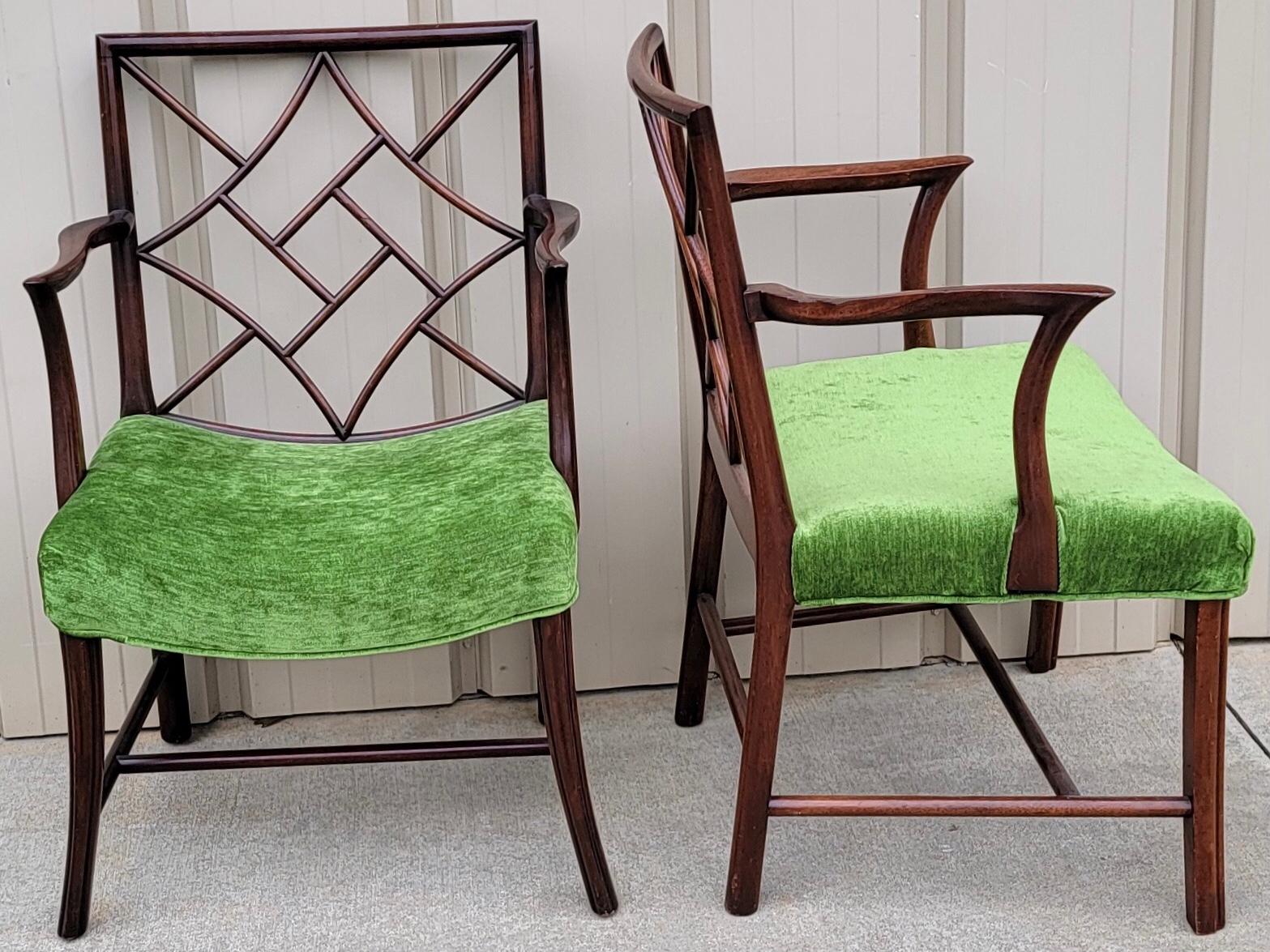 These is a near pair of 19th century carved mahogany Chinese chippendale style chairs. The green velvet is in very good condition. One of the chairs is 22.5”L x 21”W x 33.75”H. Arm is 26.5, and the seat is 18”.