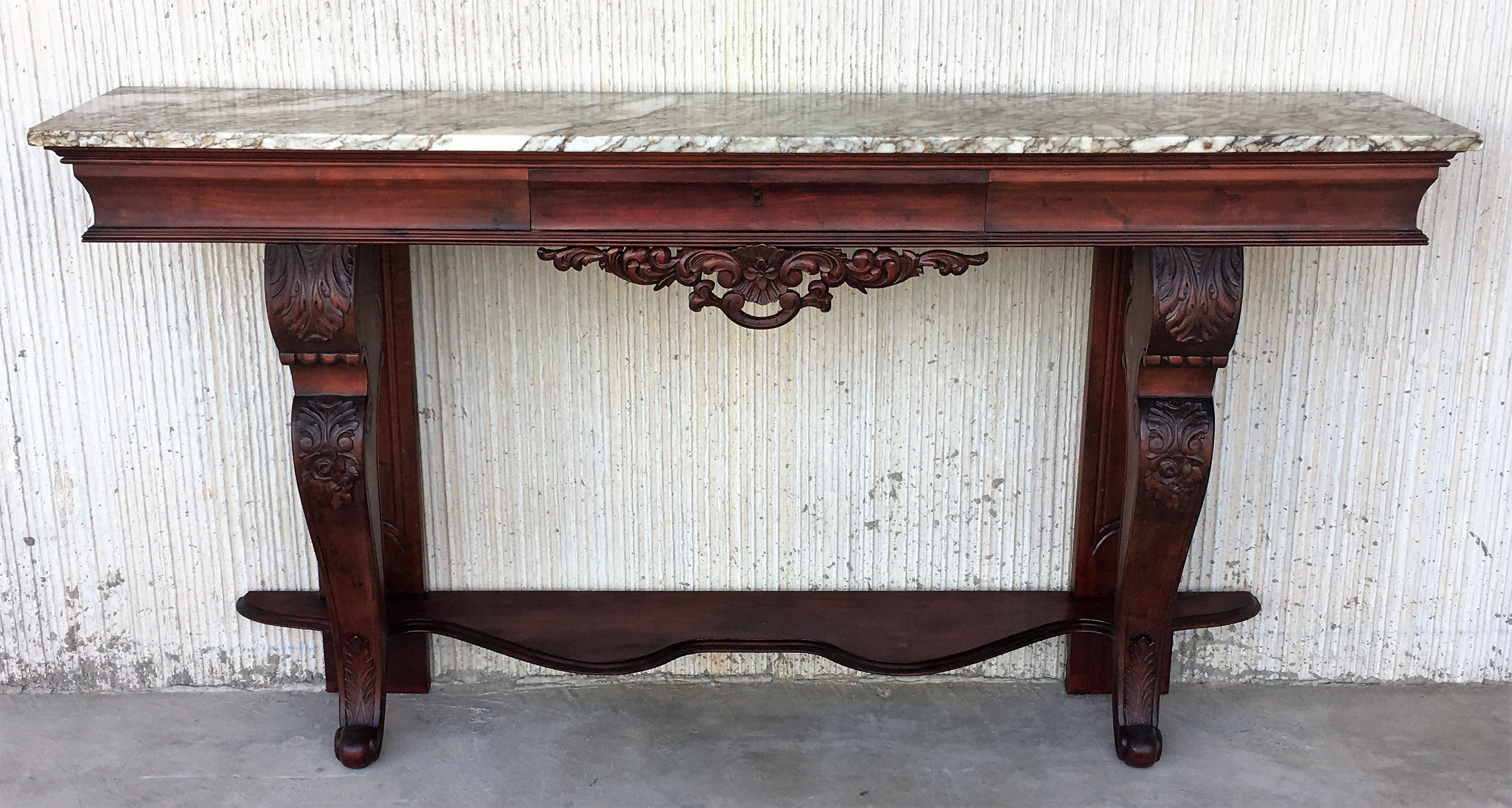 19th century carved mahogany console with marble top and central drawer.