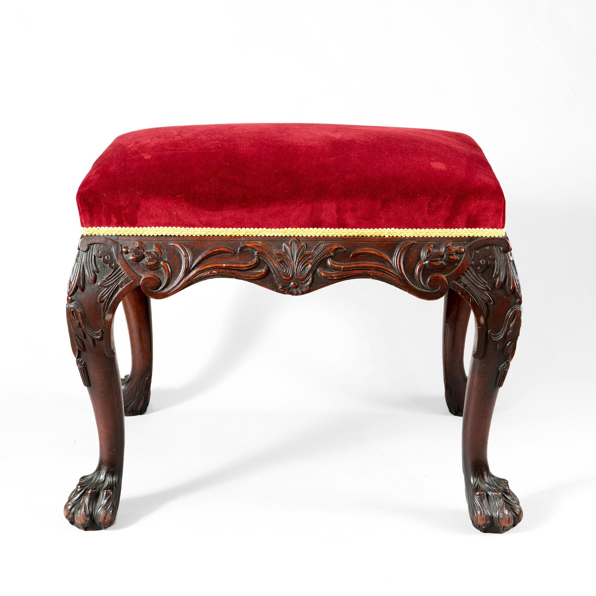 Nicholas Wells antiques is pleased to present for sale a 19th century stool with bold carved details and ornament around the apron consisting of acanthus leaves, strapwork, and floral motifs. The cabriole legs terminating in bold hairy paw