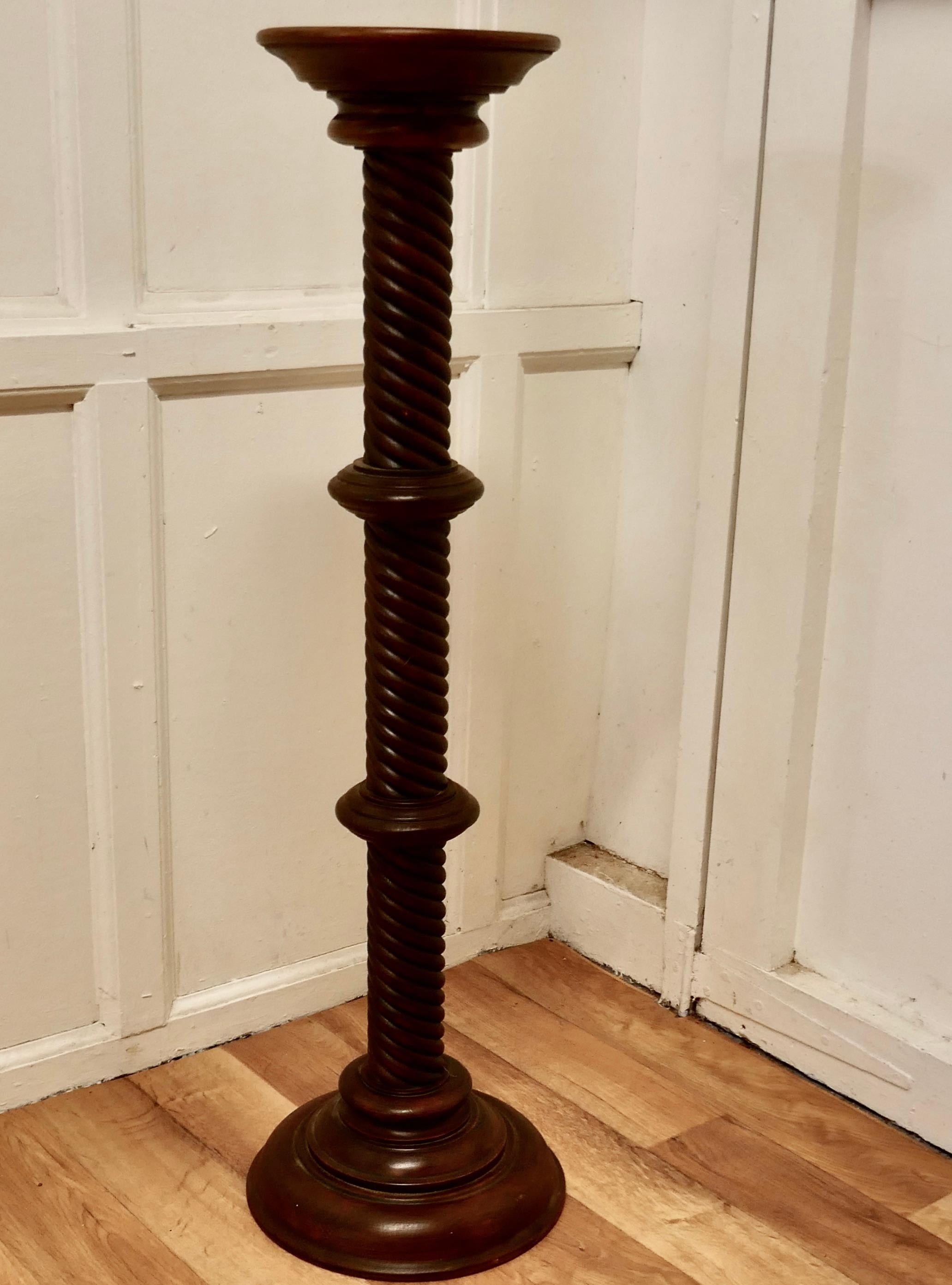 19th century carved mahogany pedestal torchere

The column has a tight barley twist turning, both top and bottom are round, the top has a small lip and the base is stepped 
The Column is in the Classical style and has a multitude of uses, for a