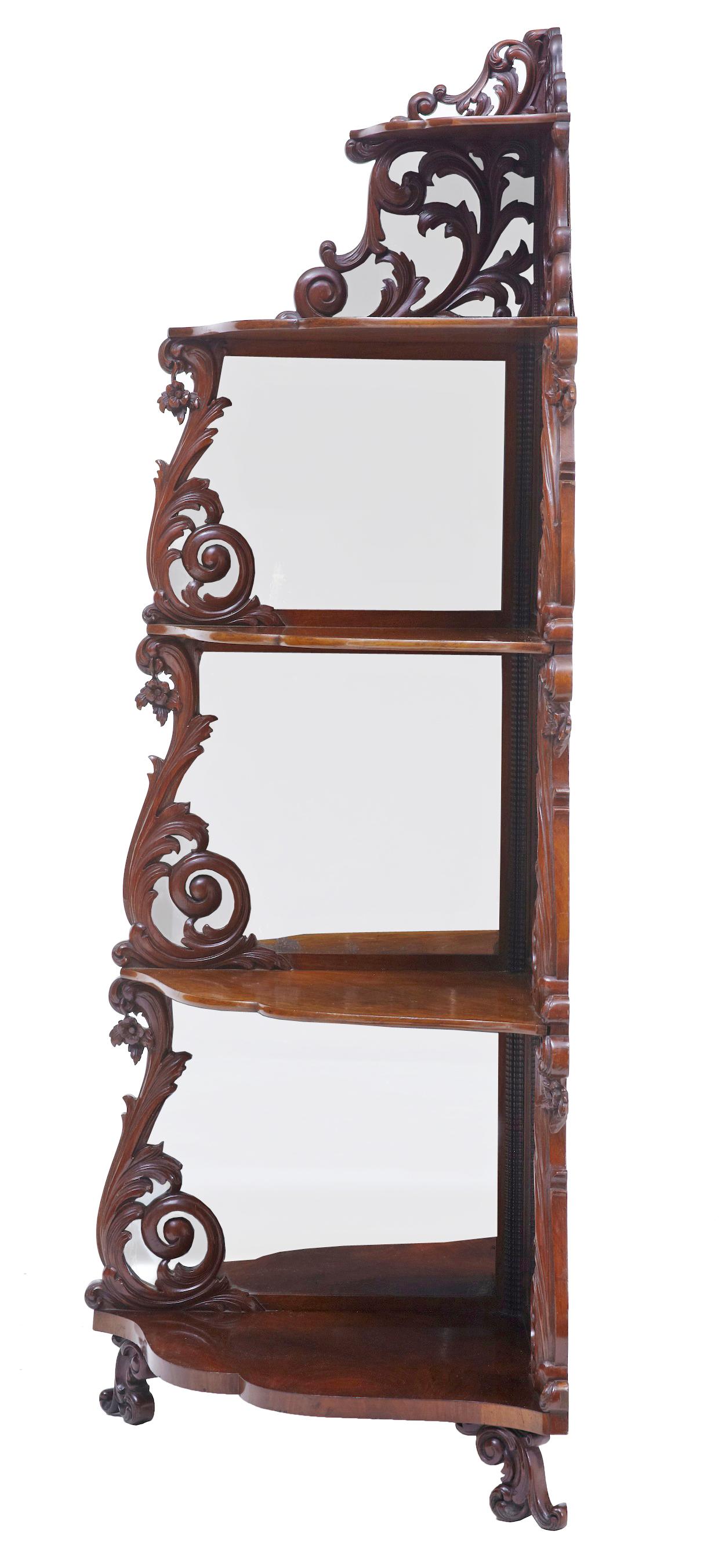 19th century carved mahogany Victorian mirrored whatnot circa 1890.

Ornate 5 tier corner whatnot made in mahogany. Each level decorated with pierced carved scrolls with mirrored backs behind the carving.

Standing on petit scrolled