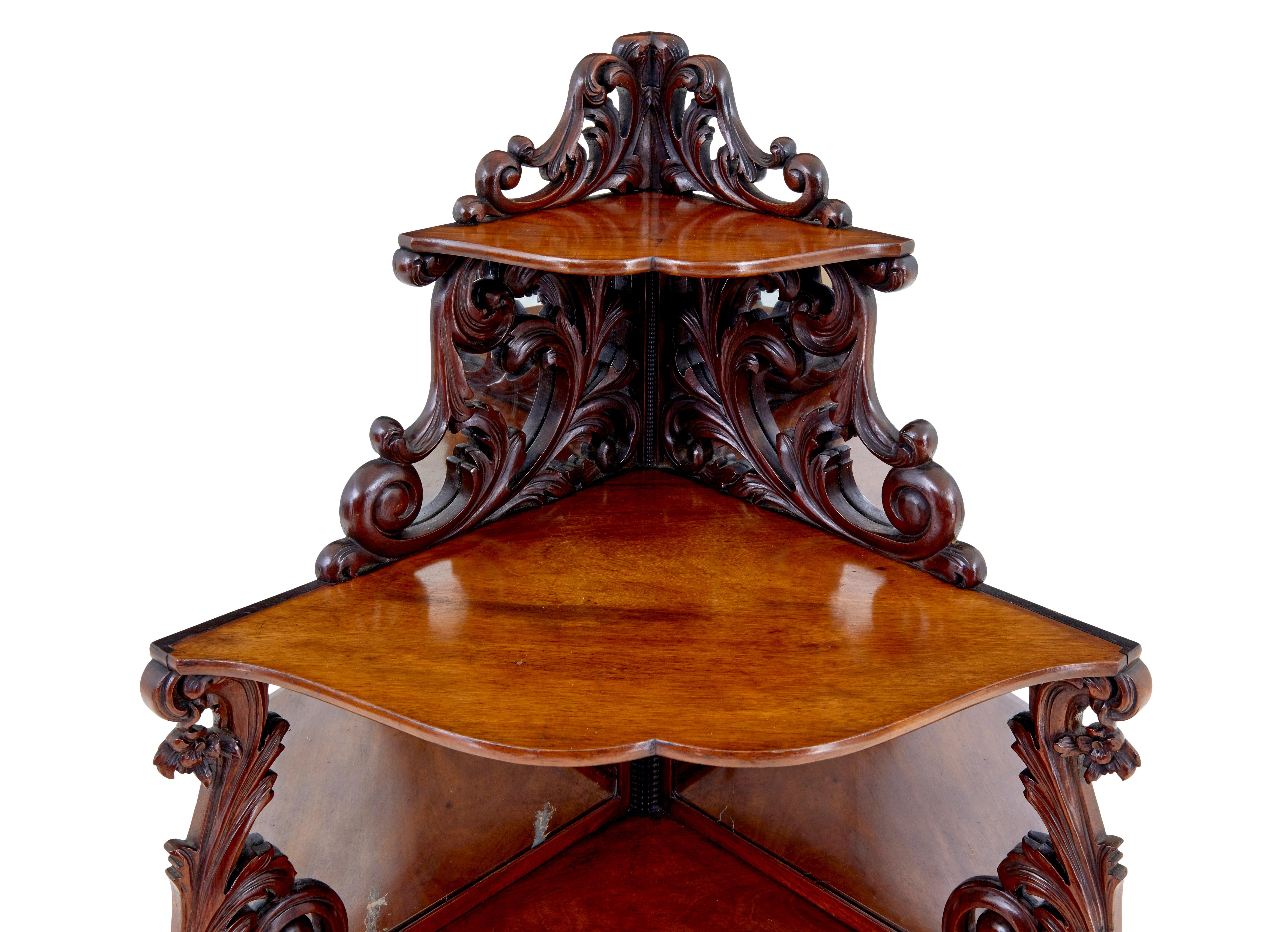 19th century carved mahogany victorian mirrored whatnot circa 1890.

Ornate 5 tier corner whatnot made in mahogany. Each level decorated with pierced carved scrolls with mirrored backs behind the carving.

Standing on petit scrolled legs, ready to