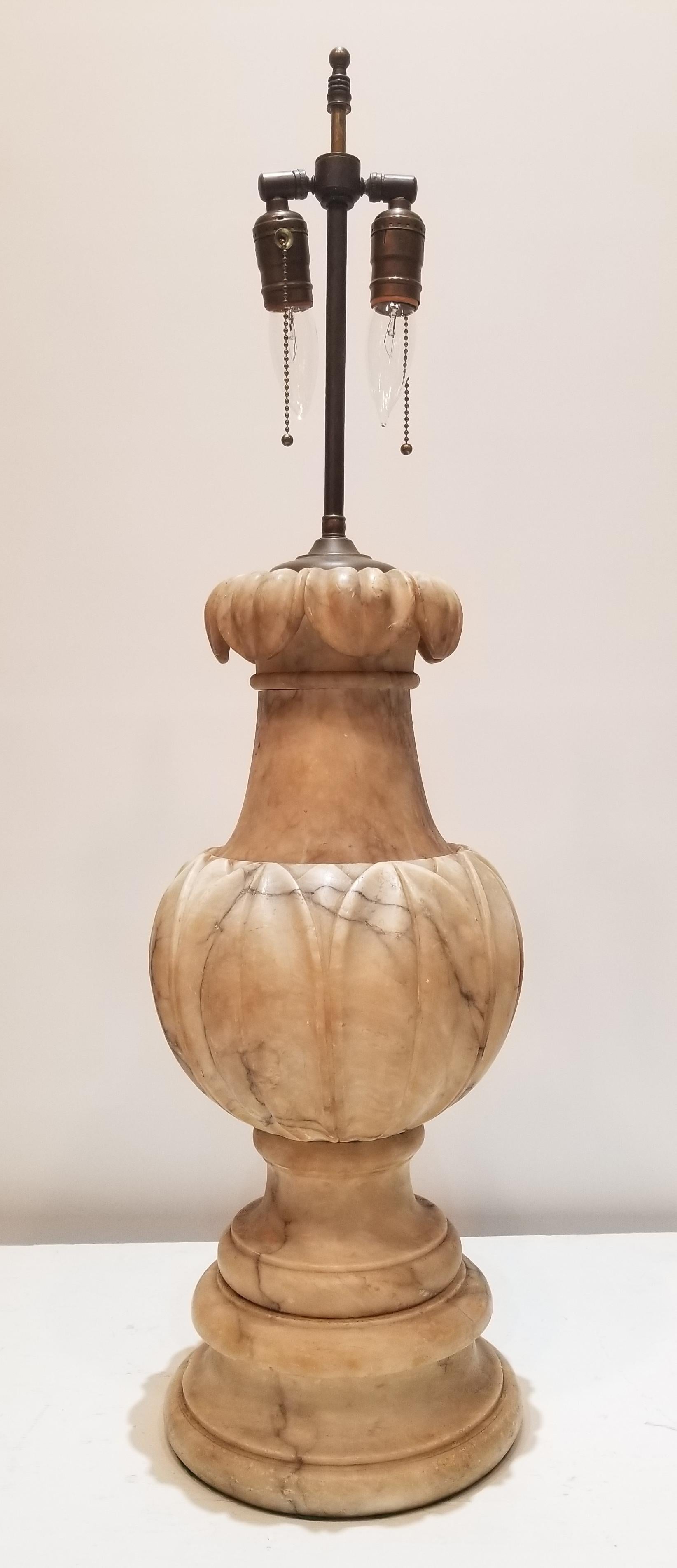Grand 19th Century Carved Marble Urn, Mounted as a Lamp. This beautiful Urn is carved with Water Lily leaves around the body with the top opening like a fountain.

 


 