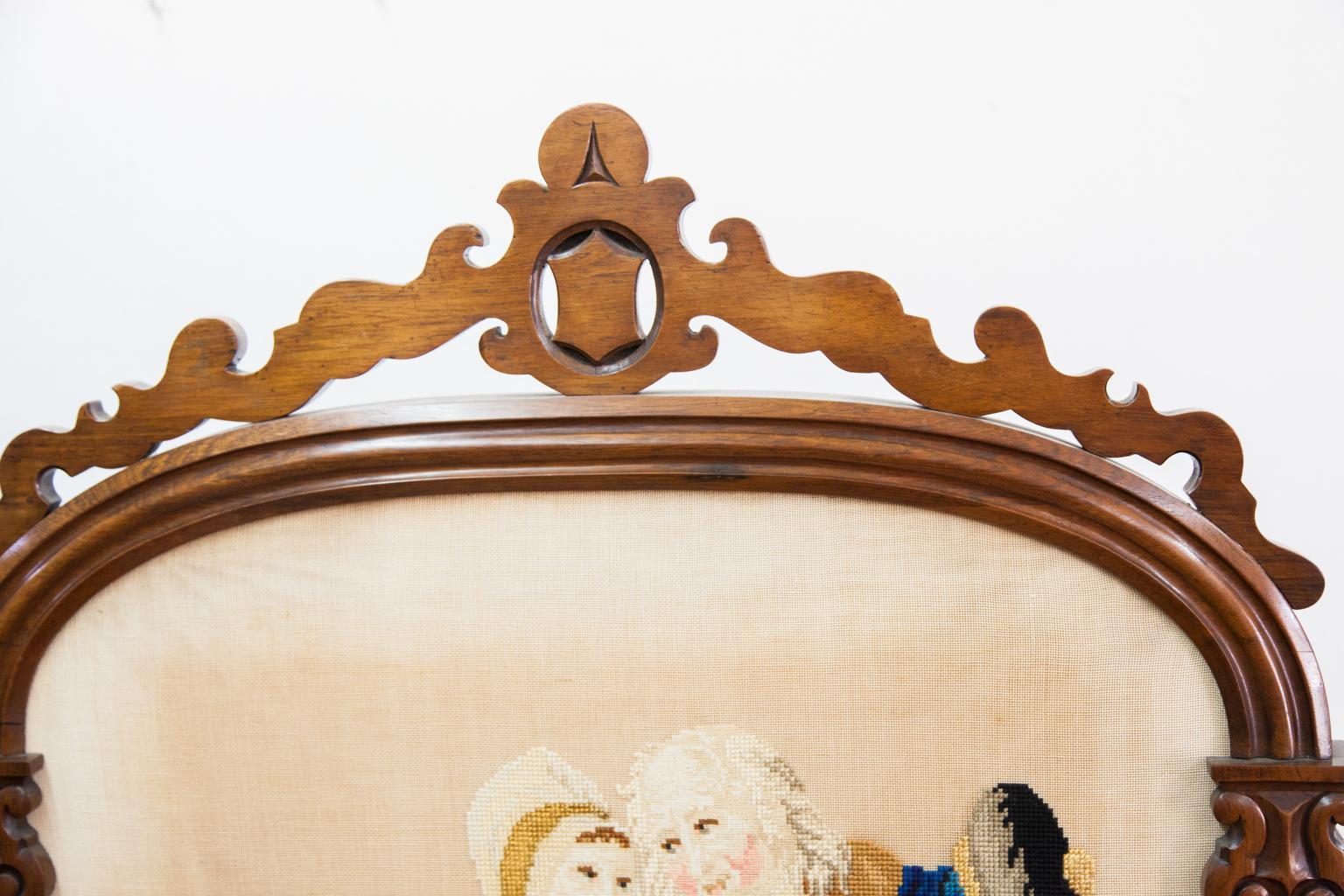 19th century carved needlework fire screen, the frame made from solid rosewood with a needlepoint and petit point panel.