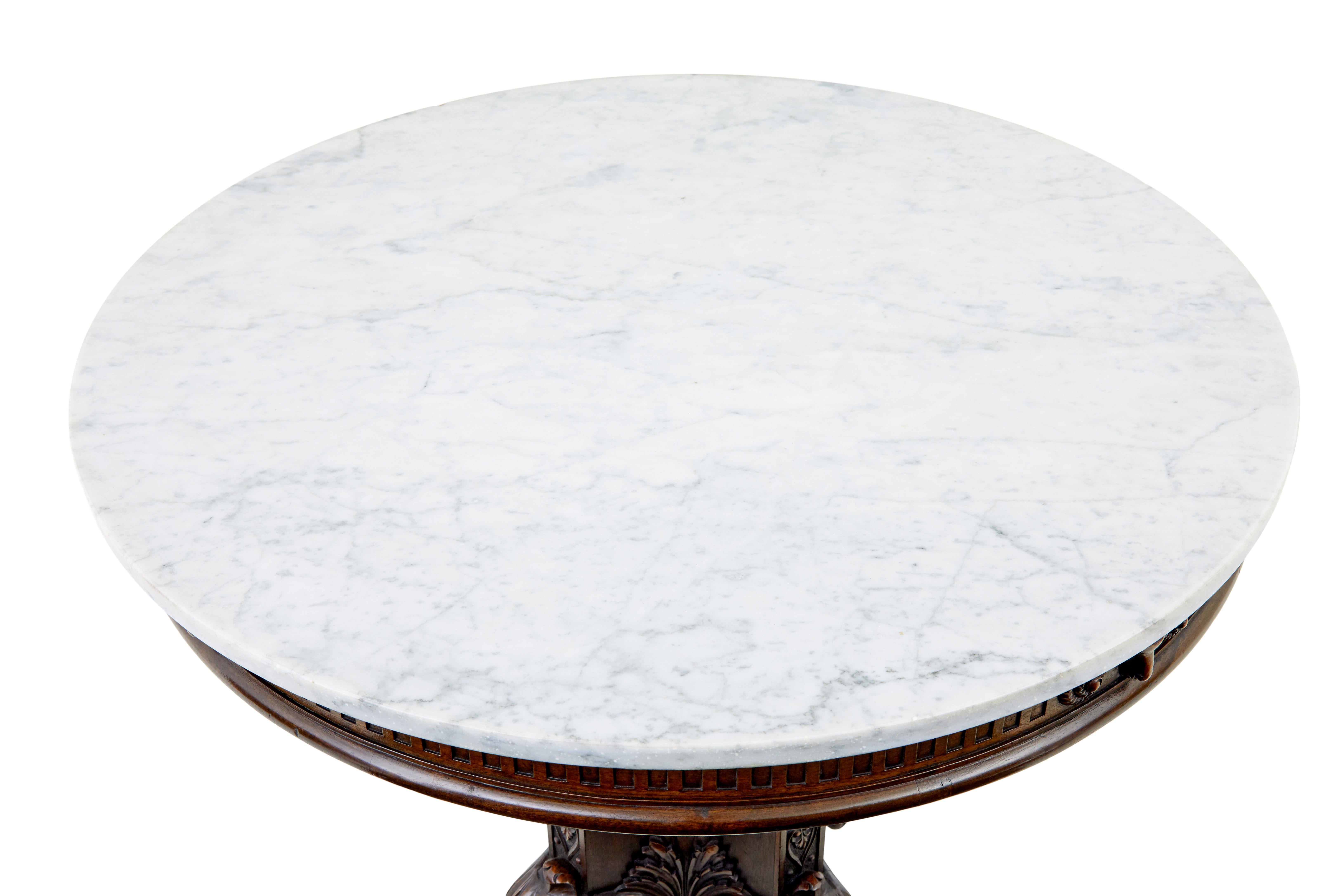 19th century carved oak and marble center table circa 1880.

Fine quality circular marble top center table.  White marble with grey veining and rounded edge, sits on a frieze of carved rams heads, fluting and a moulded edge.  Supported by a 4 sided