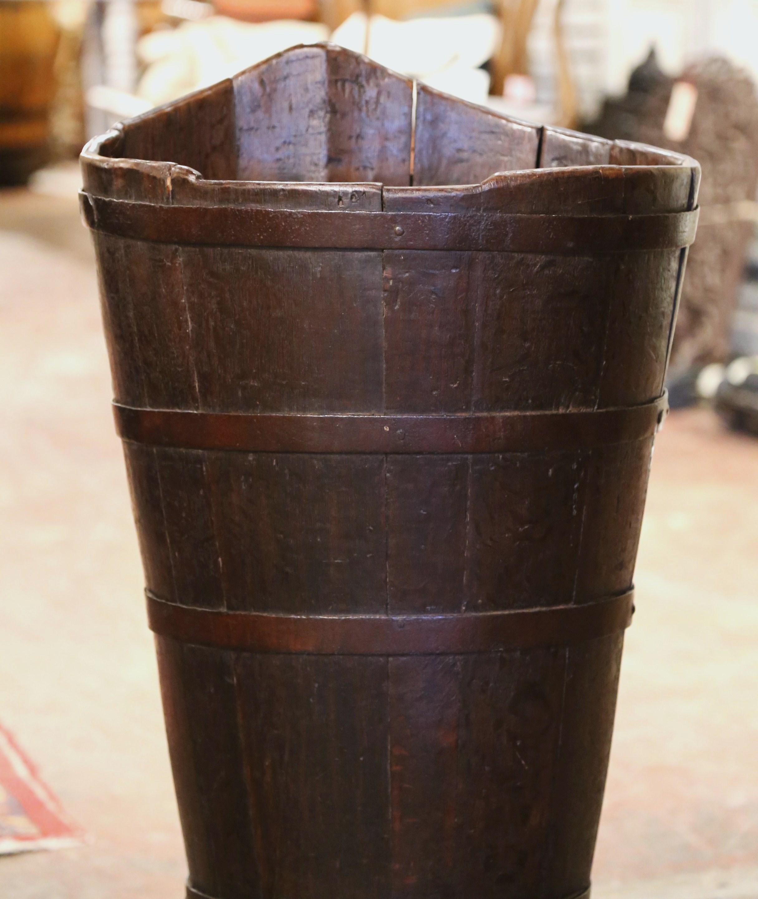 Decorate a wine cellar or breakfast room with this elegant antique grape harvest basket. Created in Burgundy, France circa 1880, the tall tapered basket with metal strapping is decorated with brackets for leather back straps, so that it can be