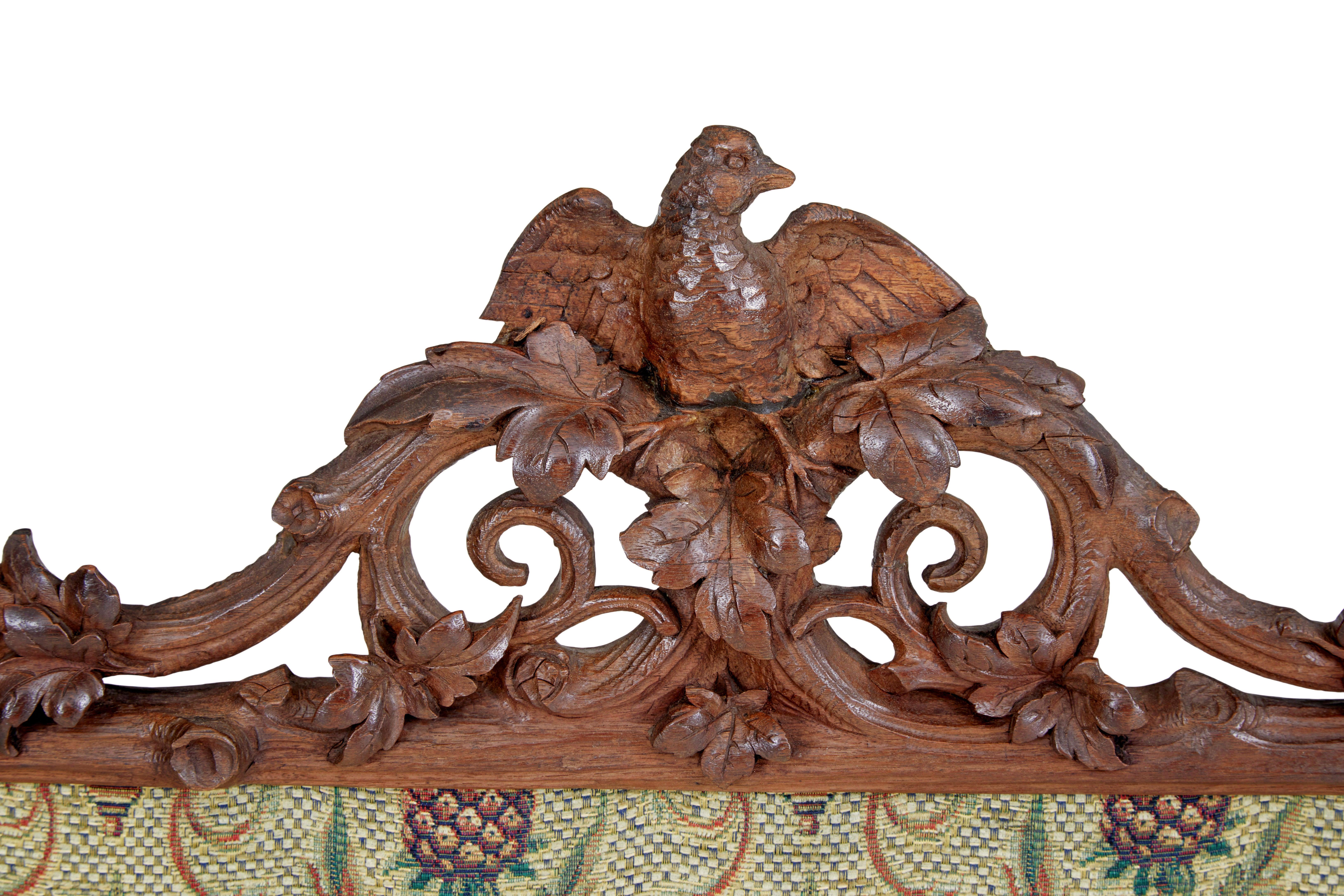 19th century carved oak black forest fire screen circa 1880.

Beautifully carved example of black forest woodwork.  Typical foliage and scrolling carved branches surmounted by a carved bird.  Standing on a carved tripod base.

Replaced tapestry in