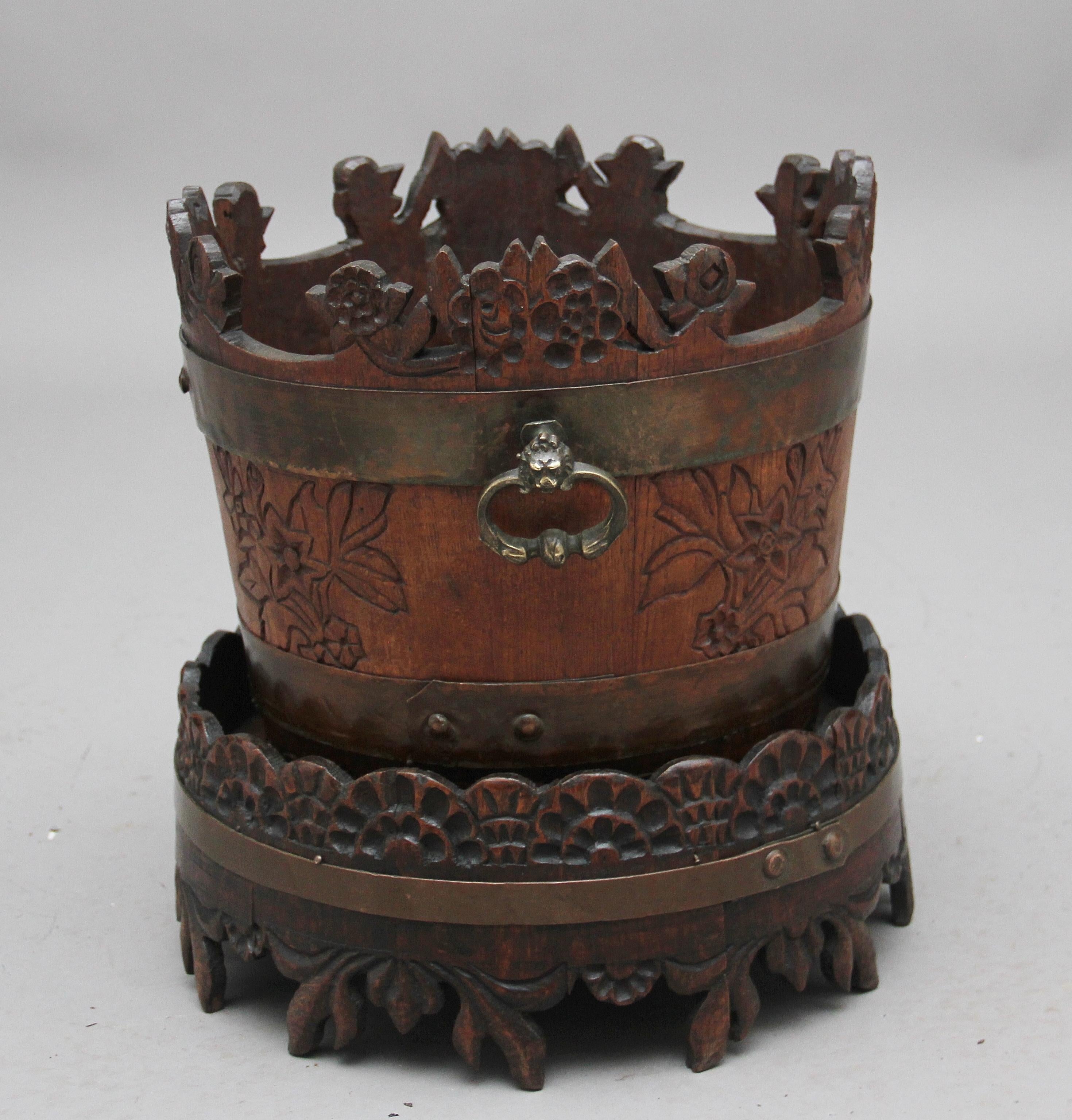 Mid-19th century oak carved bucket on stand, possibly Scandinavian, the bucket has two brass handles and the stand has one brass band, bother the stand and bucket has lovely naive carving, circa 1840.
  