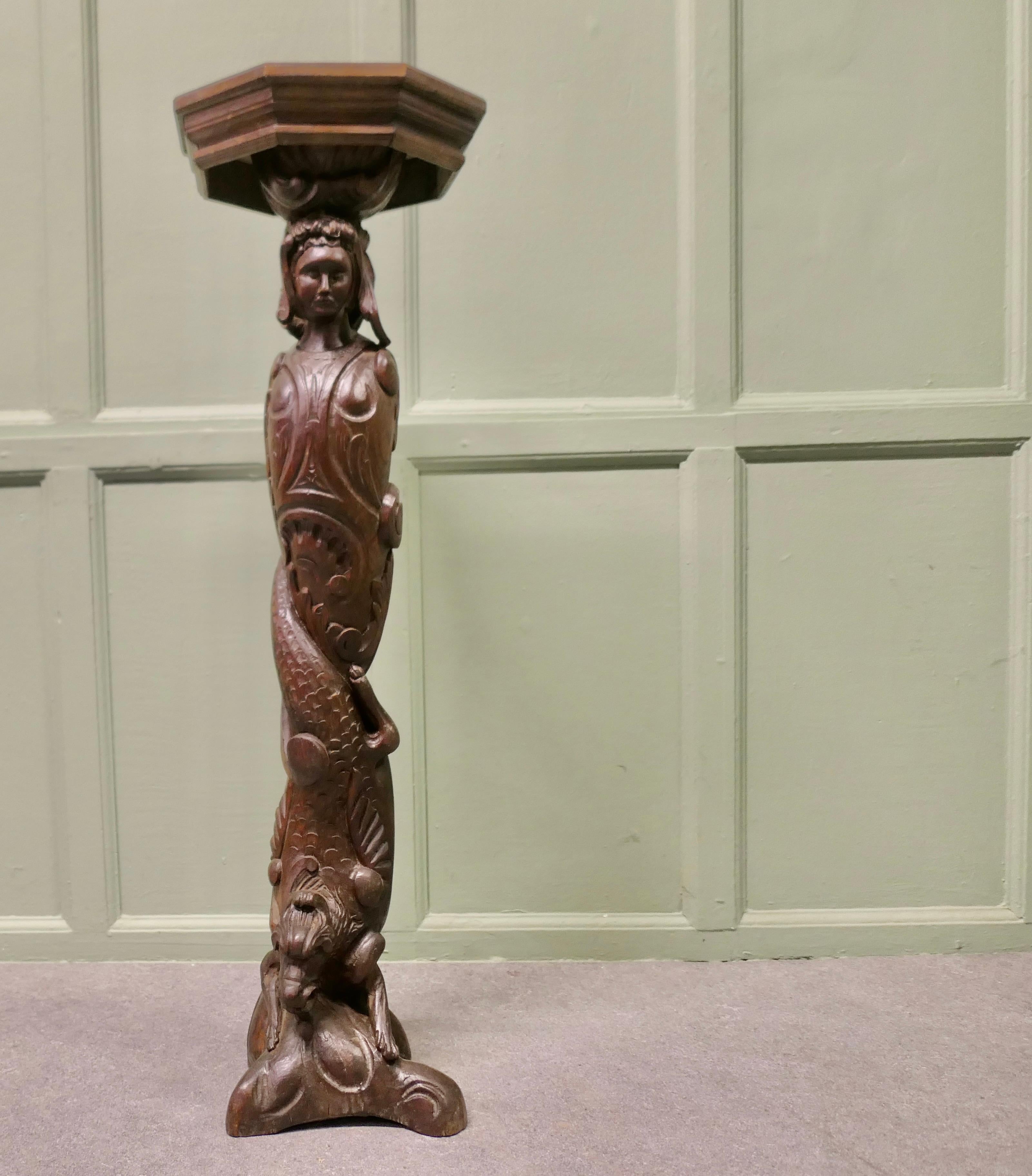 19th Century Carved Oak Caryatid Pedestal

This is a superbly carved piece of 19th Century carving, it probably originated from a piece of furniture from where it was removed in the 1930s and made into a pedestal by the addition of an Oak table