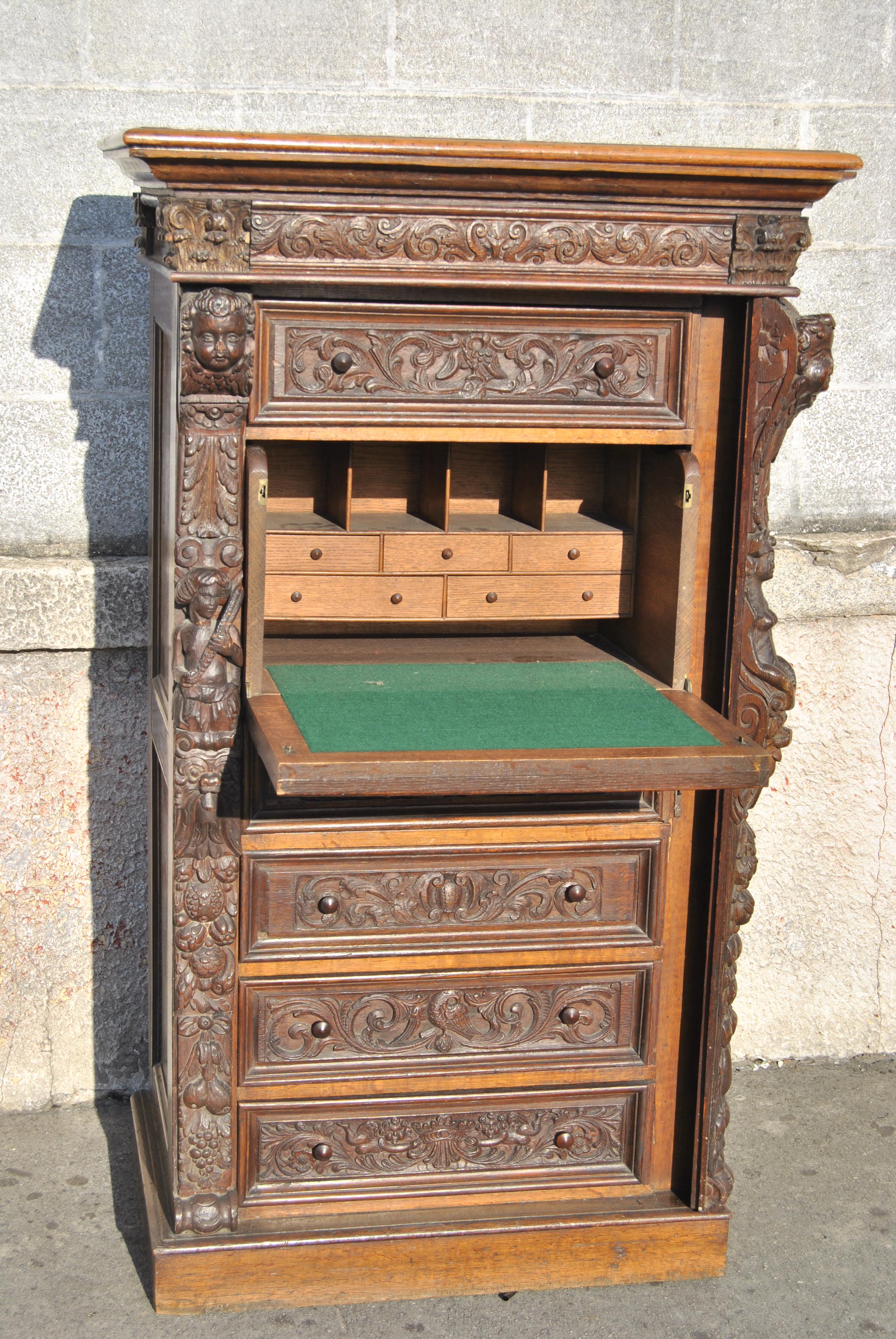 This is a solid oak wellington chest/lingerie chest/secretary made in England, circa 1880. The top of the chest has a nicely molded edge. The chest has incredible quality, very ornate and deep hand carving throughout. Like all true Wellington Chests