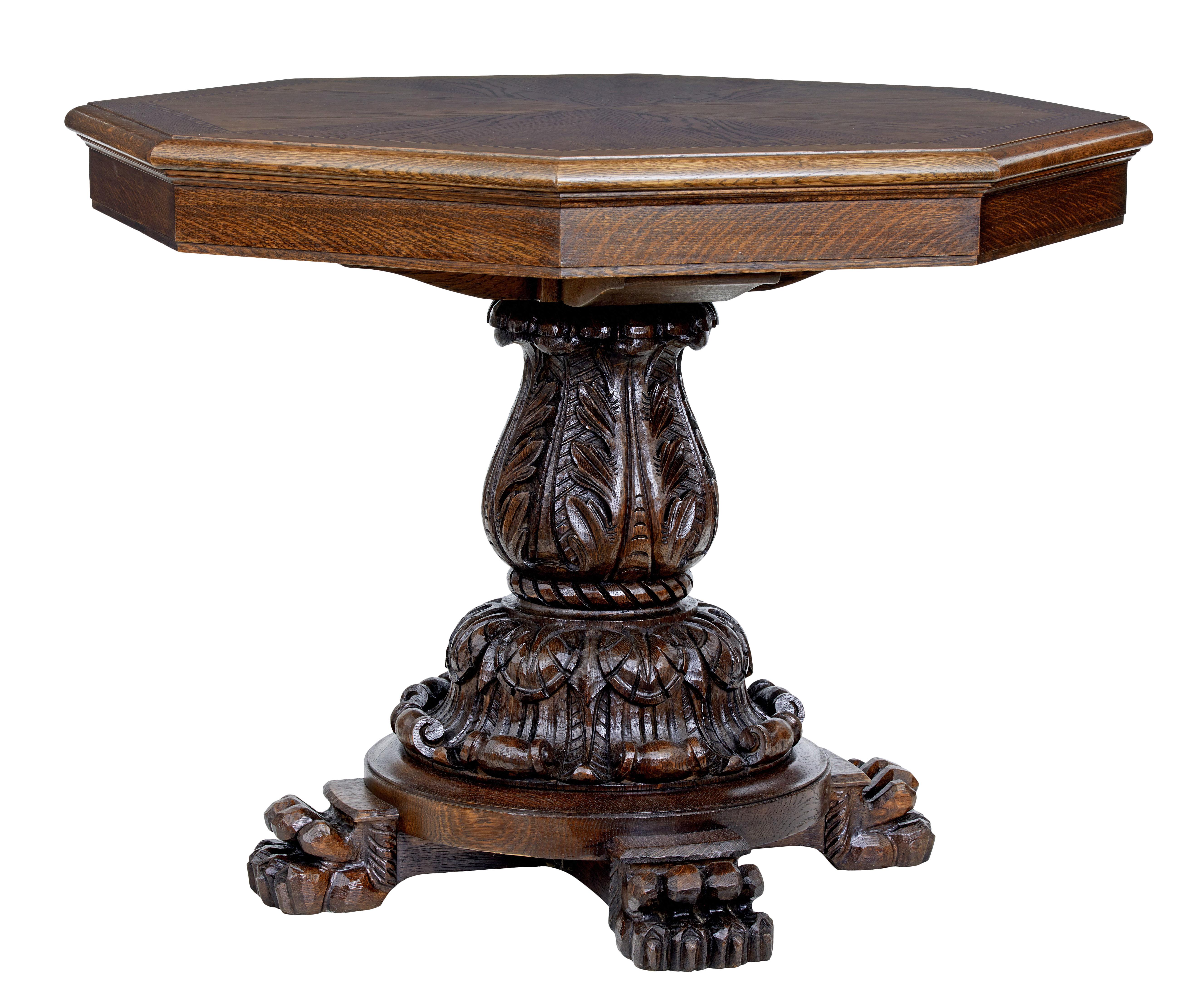 Good quality oak centre table, circa 1880.

Hexagonal top with segmented oak veneers surrounded by birch and mahogany inlay. Standing on a heavily carved stem base with acanthus leaf detailing.

Round base supported by 4 carved paw