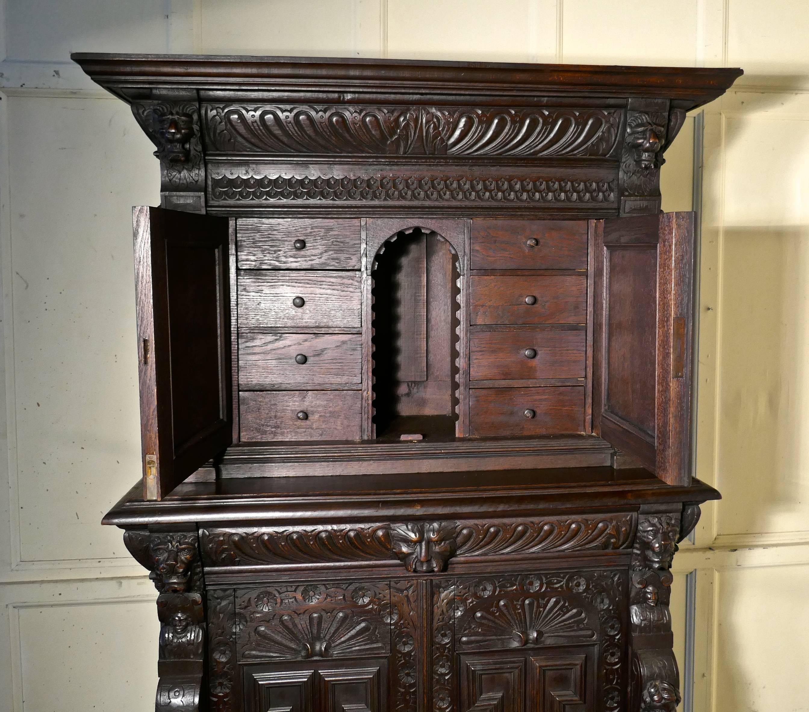 19th century carved oak housekeepers or hall cupboard.
 
This is a lovely antique cupboard, it is in two parts, the upper part has a carved cornice and a pair of doors enclosing a ledger pigeon hole with four drawers on either side
The lower