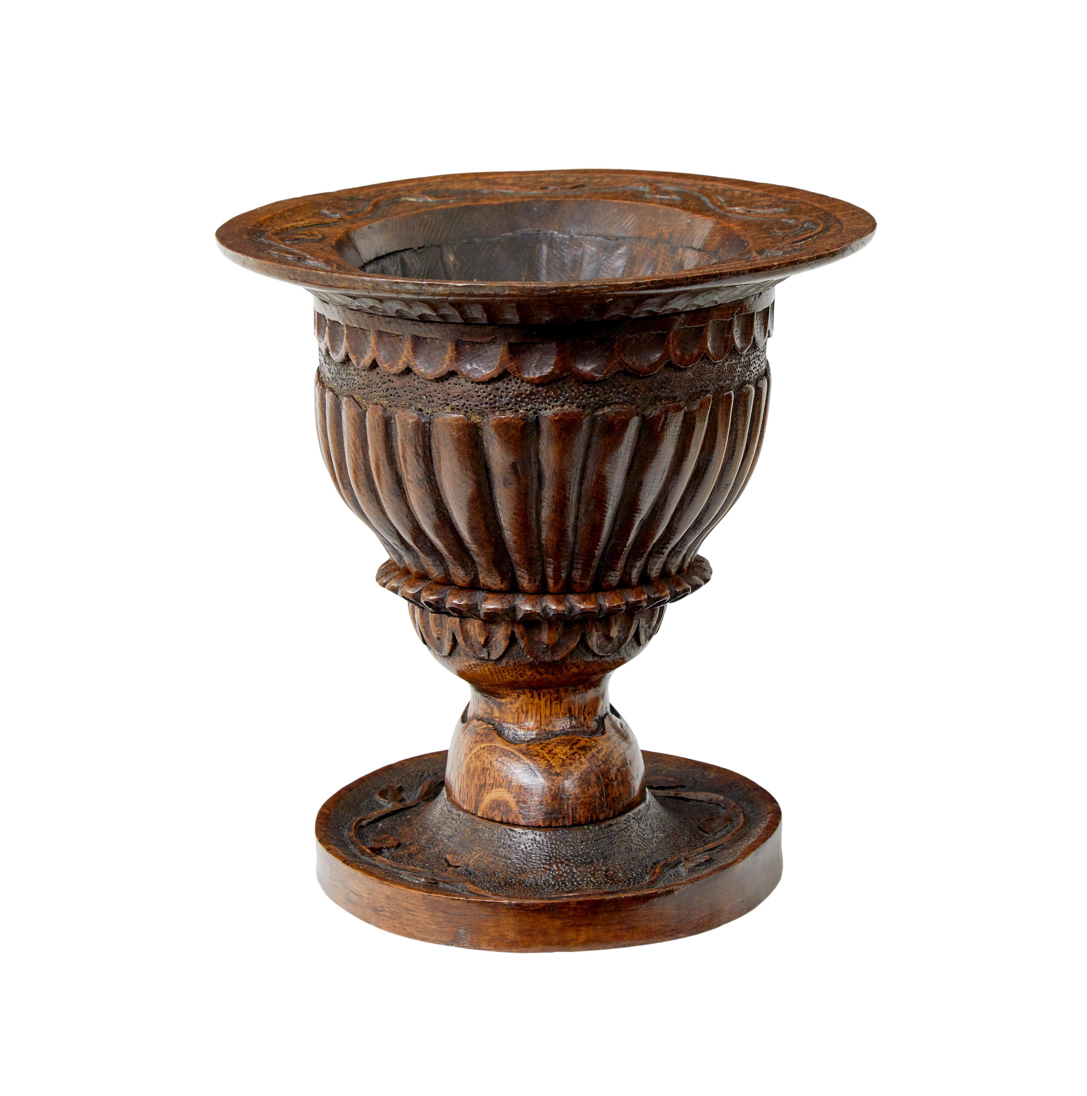 19th century carved oak liege bowl circa 1880.

Good quality carved oak liege bowl from France.  Ideal table top item, beautifully hand carved from solid oak with vines around the top rim, fluting down the sides and standing on an oval base.

Minor