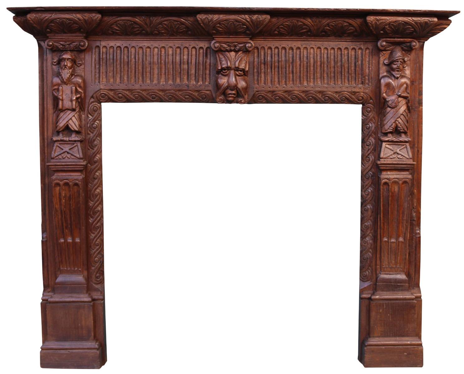 An unusual 19th century carved oak fire surround featuring craved 'Green Man' mask to the frieze and carved depictions of traders to the jambs. This has been constructed from earlier timbers, possibly 18th century elements. This fireplace is