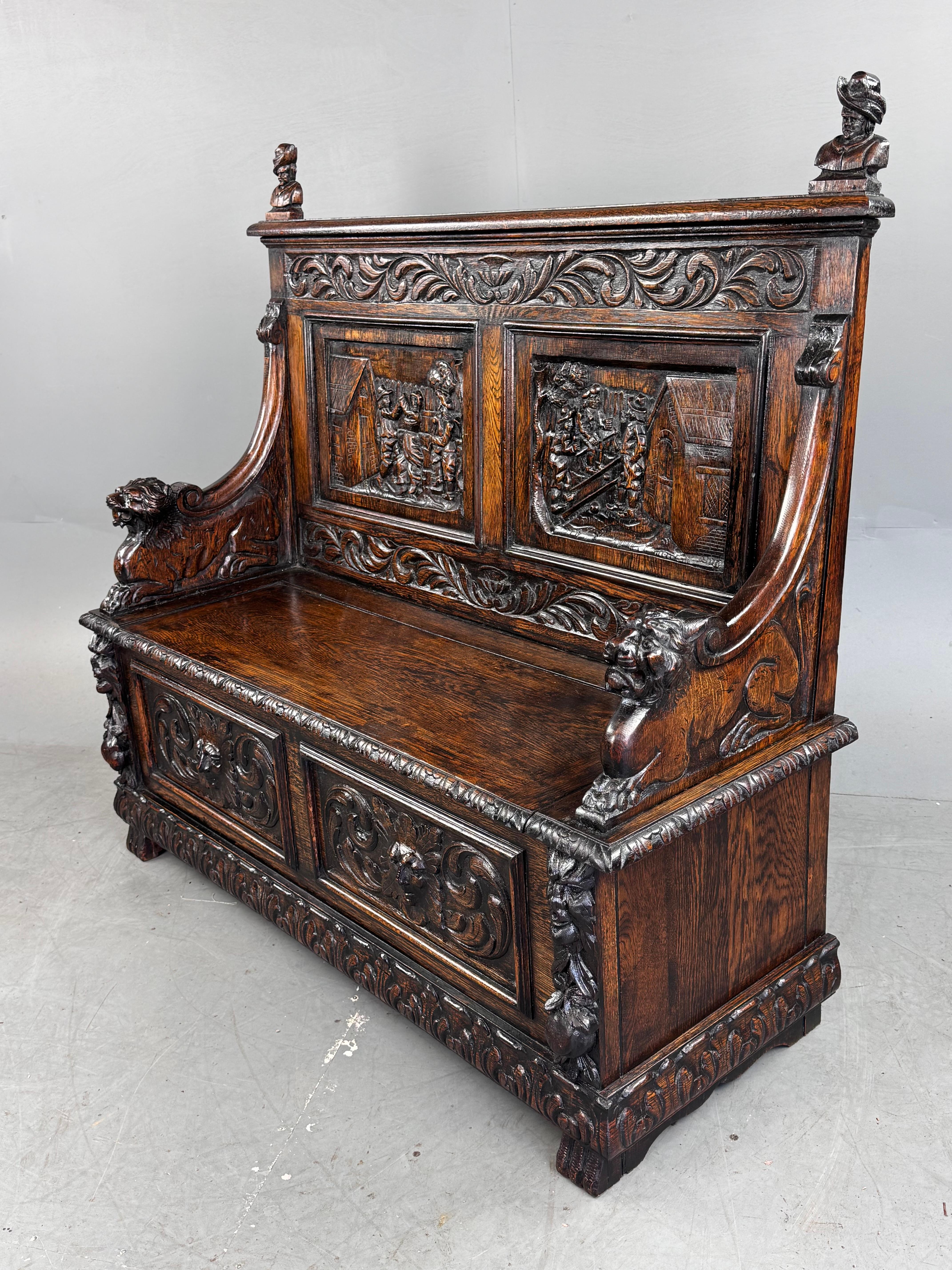 Stunning 19th century carved oak Hall bench .
The quality of the carving is top drawer ,very crisp and highly detailed The two back panels depicting men drinking at the local tavern and one locals dancing ,with each arm having a carved lion to one