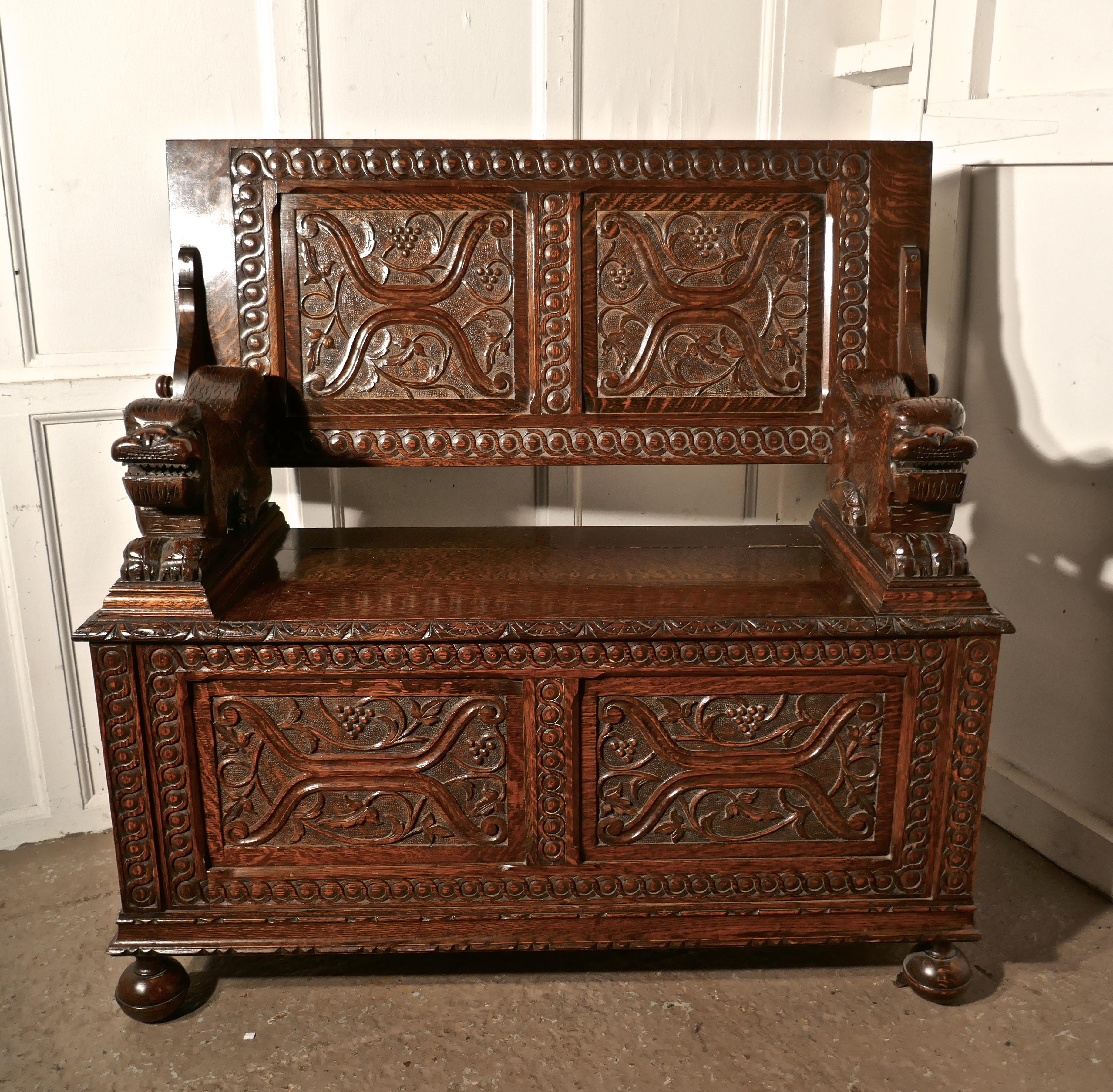 19th century carved oak monks bench settle, hall table.

This unusual piece is known as a Monks Bench, it is fact a settle with storage compartment inside the seat and the back of the bench can be pulled over, it then rests on the on the top of