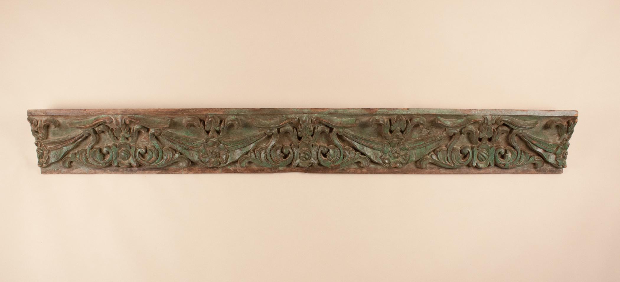 A beautiful, authentic architectural artifact from Ahmedabad, India. This circa 1850 hand carved teak wood panel is a section of ceiling cornice likely from the haveli of a prosperous Indian family. The wood is carved in 1 inch relief, and retains