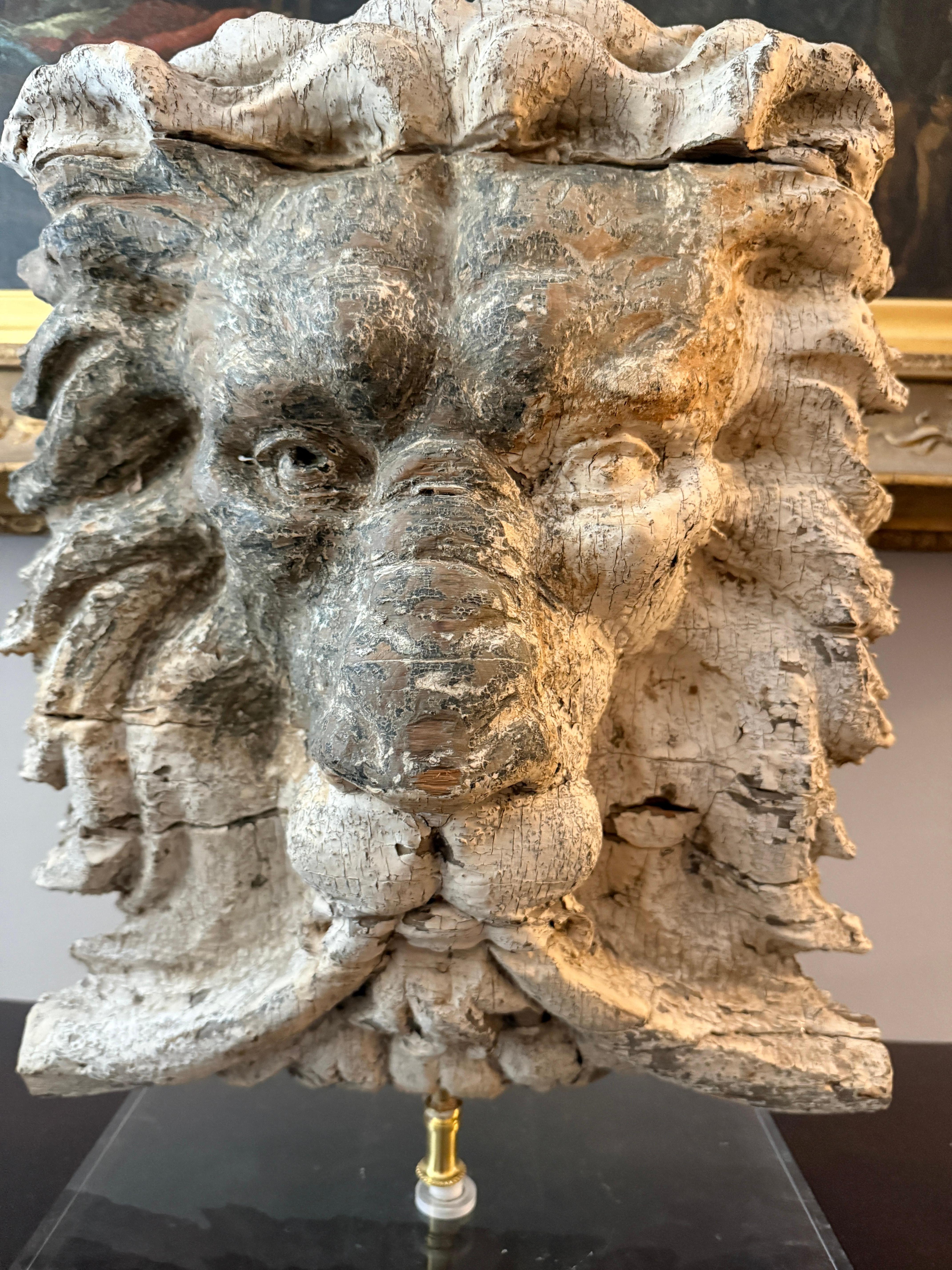 A substantial and finely carved wooden lion’s head, likely originating from a 19th-century architectural setting, such as a grand entryway, theater, or public building. This striking piece, carved from pine, exhibits remarkable craftsmanship, with