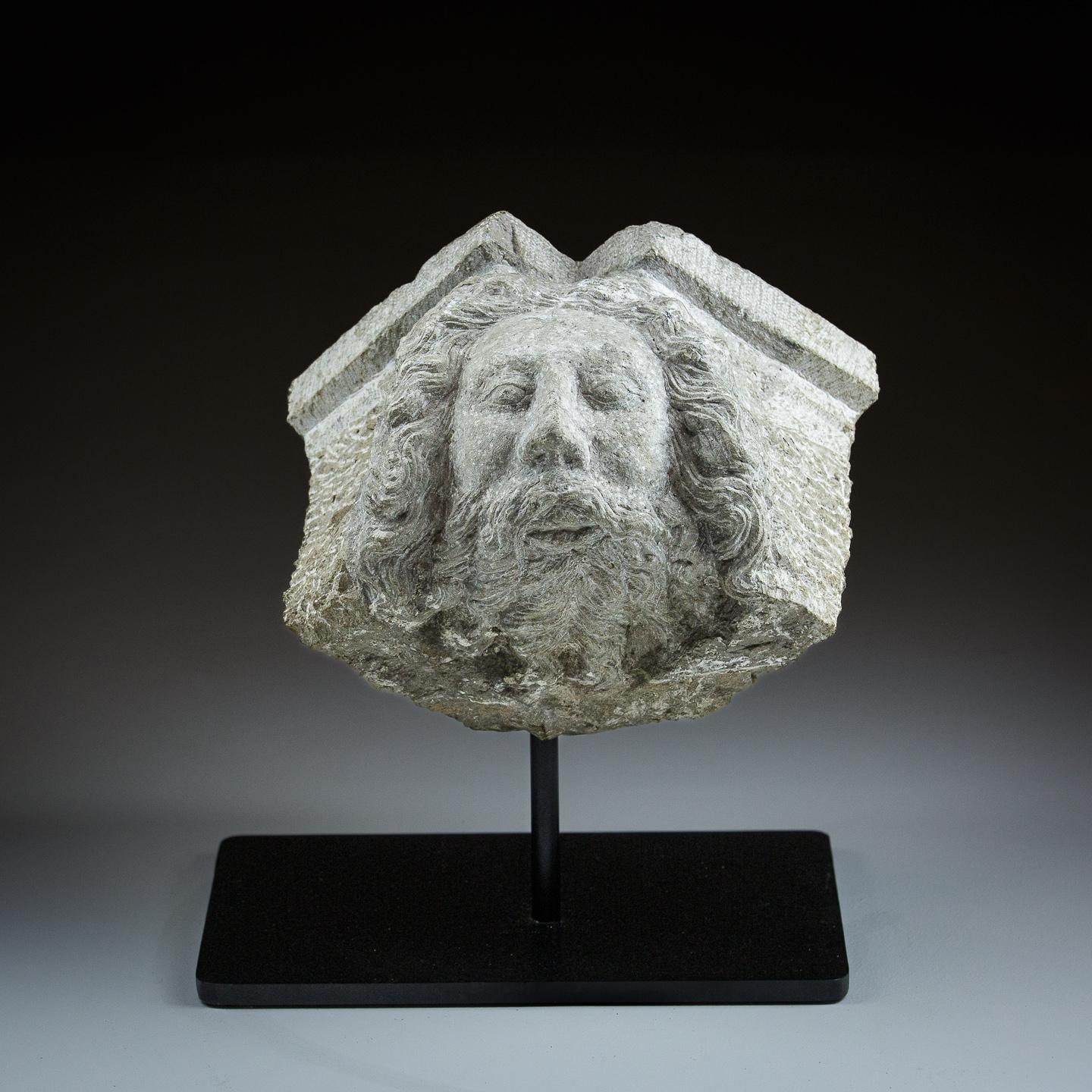 Carved Stone Head, depicting bearded figure with flowing hair. Possibly Neptune. Large Building pediment fragment. France Circa 19th Century. Measurement for fragment itself not including stand.