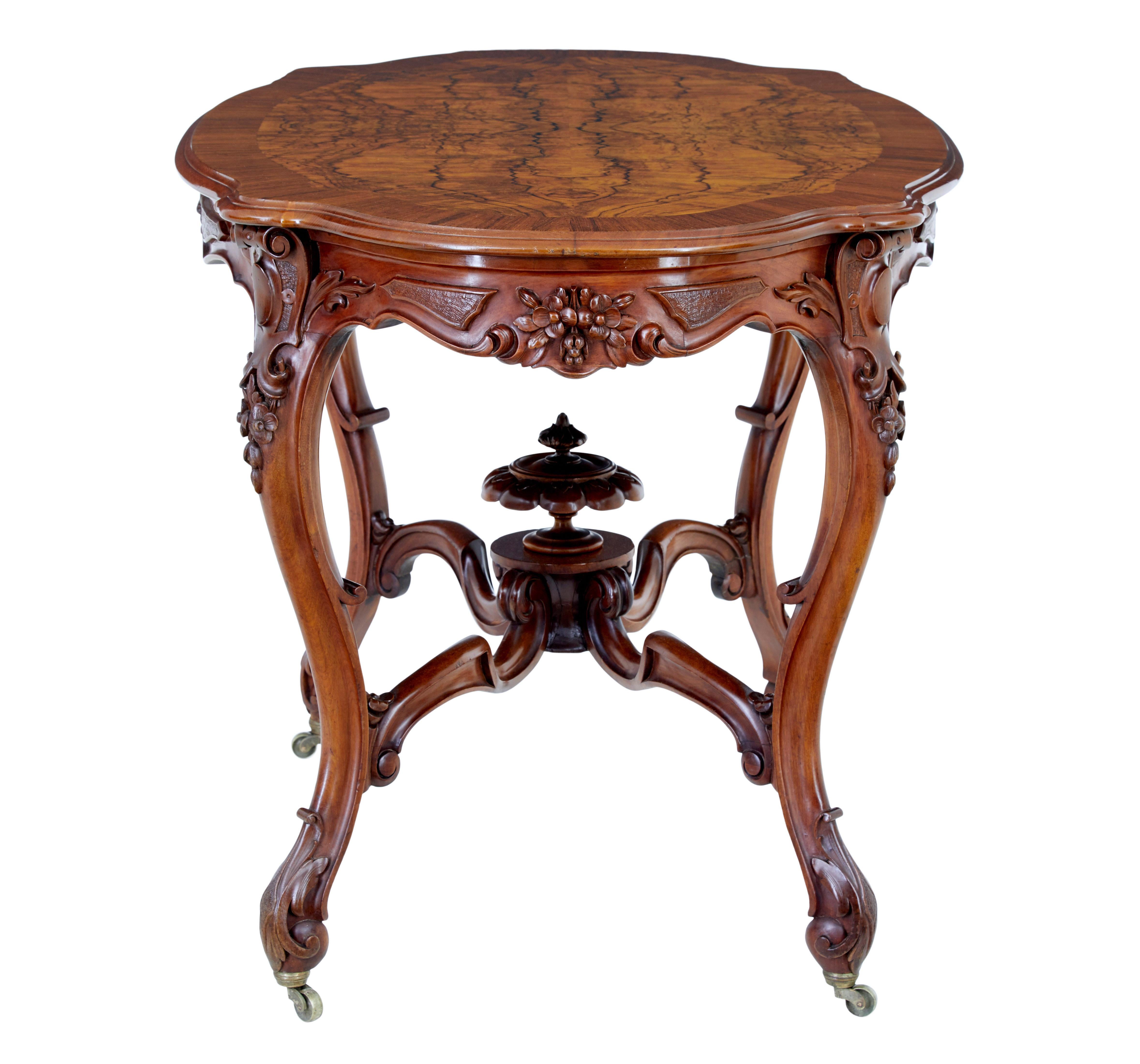 19th century carved walnut occasional table circa 1890.

Fine quality rococo revival swedish made table.  Dimensions of this table lends itself to multiple uses, such as a centre, sofa or side table.

Cartouche shaped top with a matched burr walnut