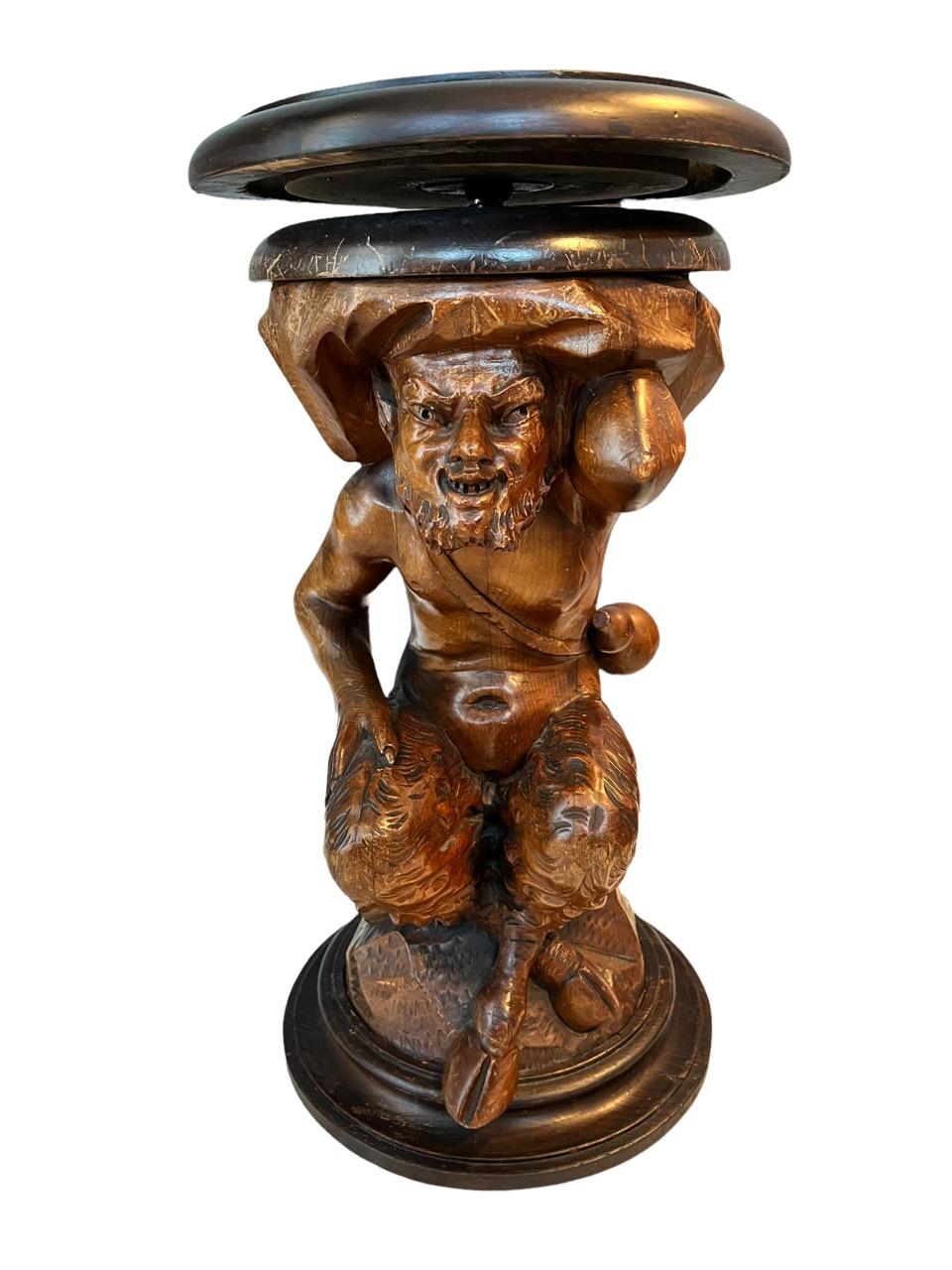 19th Century carved walnut piano stool, Black Forest in the shape of a faun, which is a mythological half human half goat creature from Roman mythology. The height is adjustable to up to 31in high.
 
