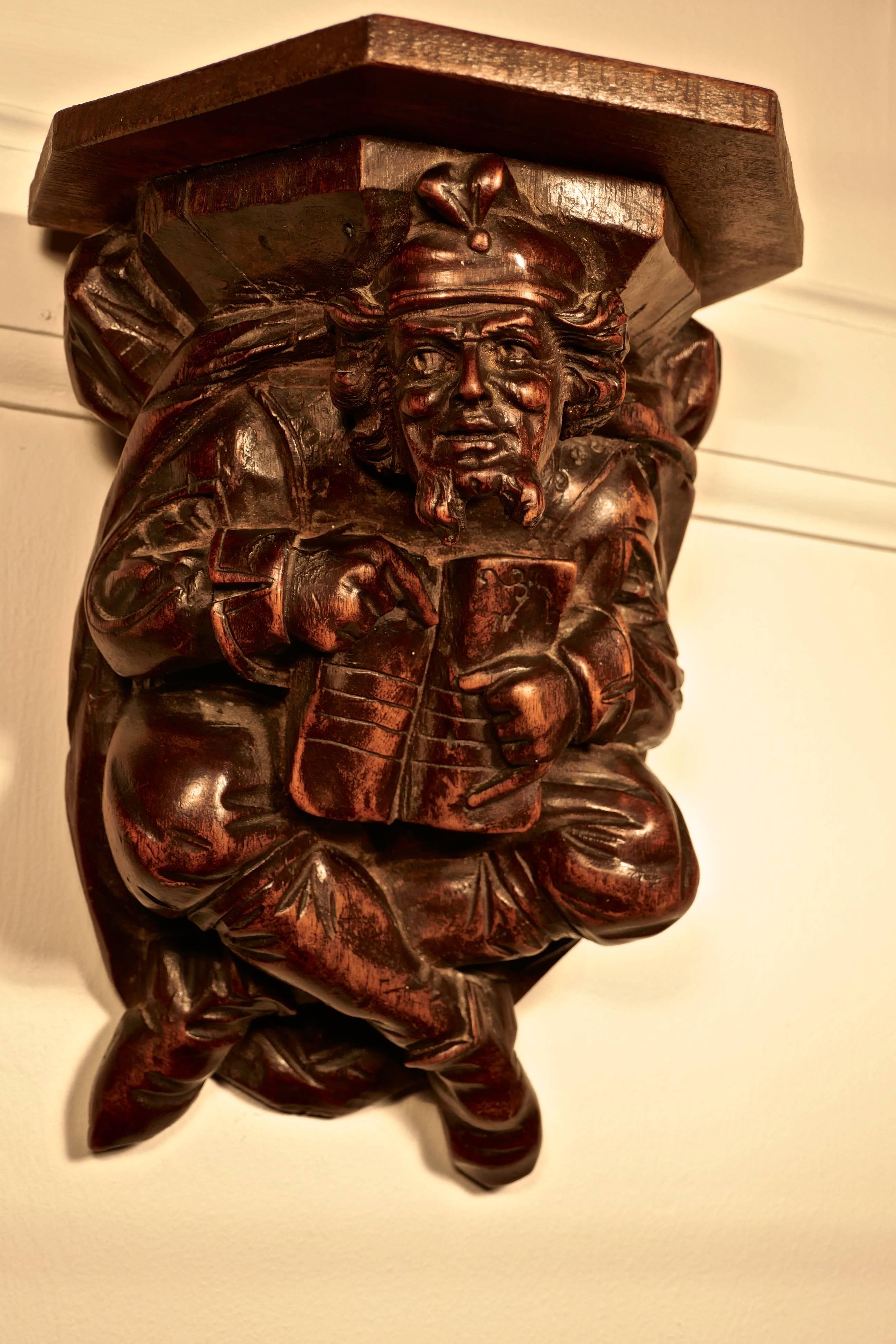 A 19th century carved walnut wall bracket, Medieval magician

This is a beautifully carved piece, depicting a Medieval magician reading from his book of spells, he hangs crossed legged and has a piercing expression in his eyes

The bracket had a