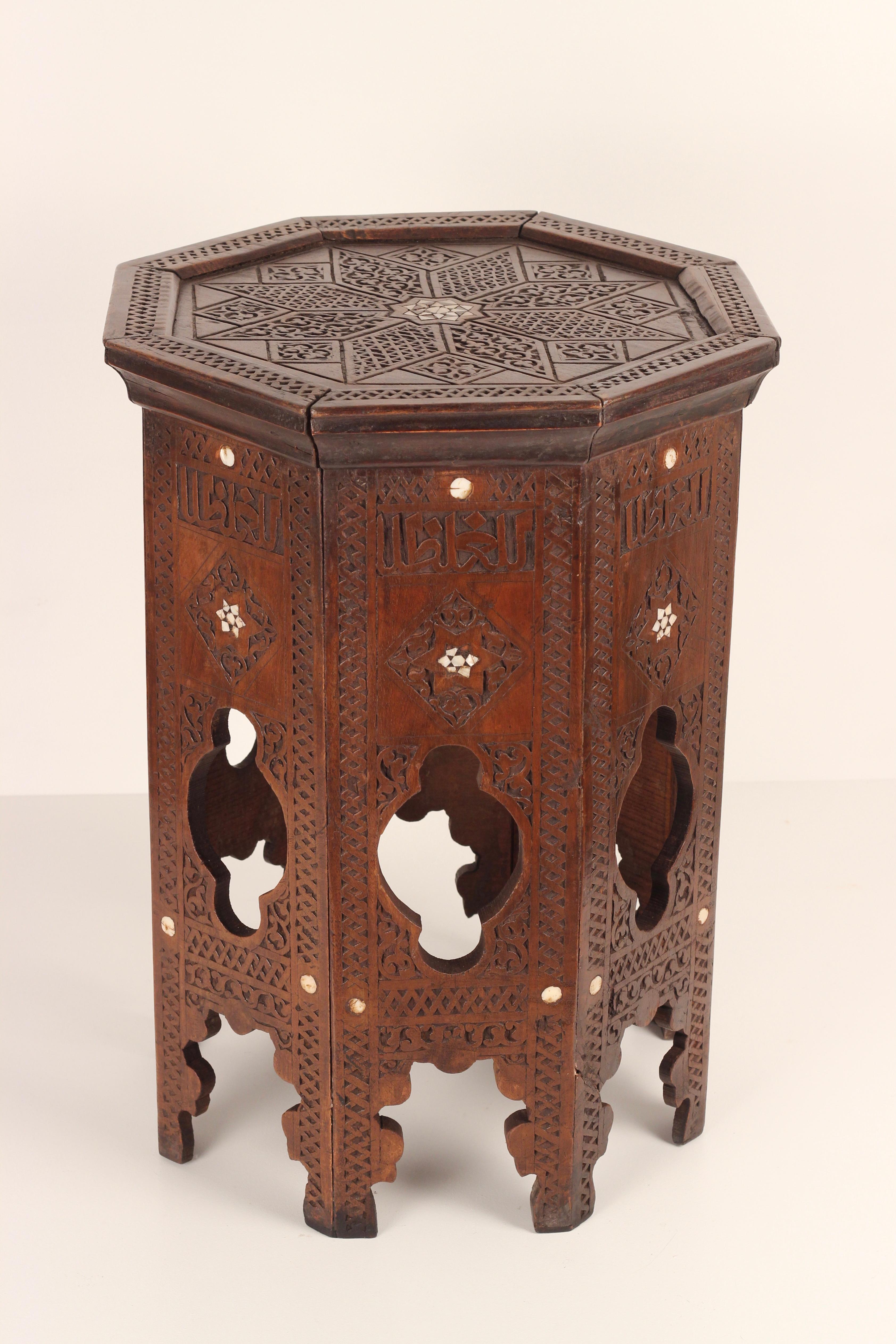 Antique Ottoman side table made around the end of the 19th century from Northern Africa. An ornately carved geometric design with delicate Bone inlay flowers in the Style of the Ottomans. This Hexagonal table serves as a functional and practical
