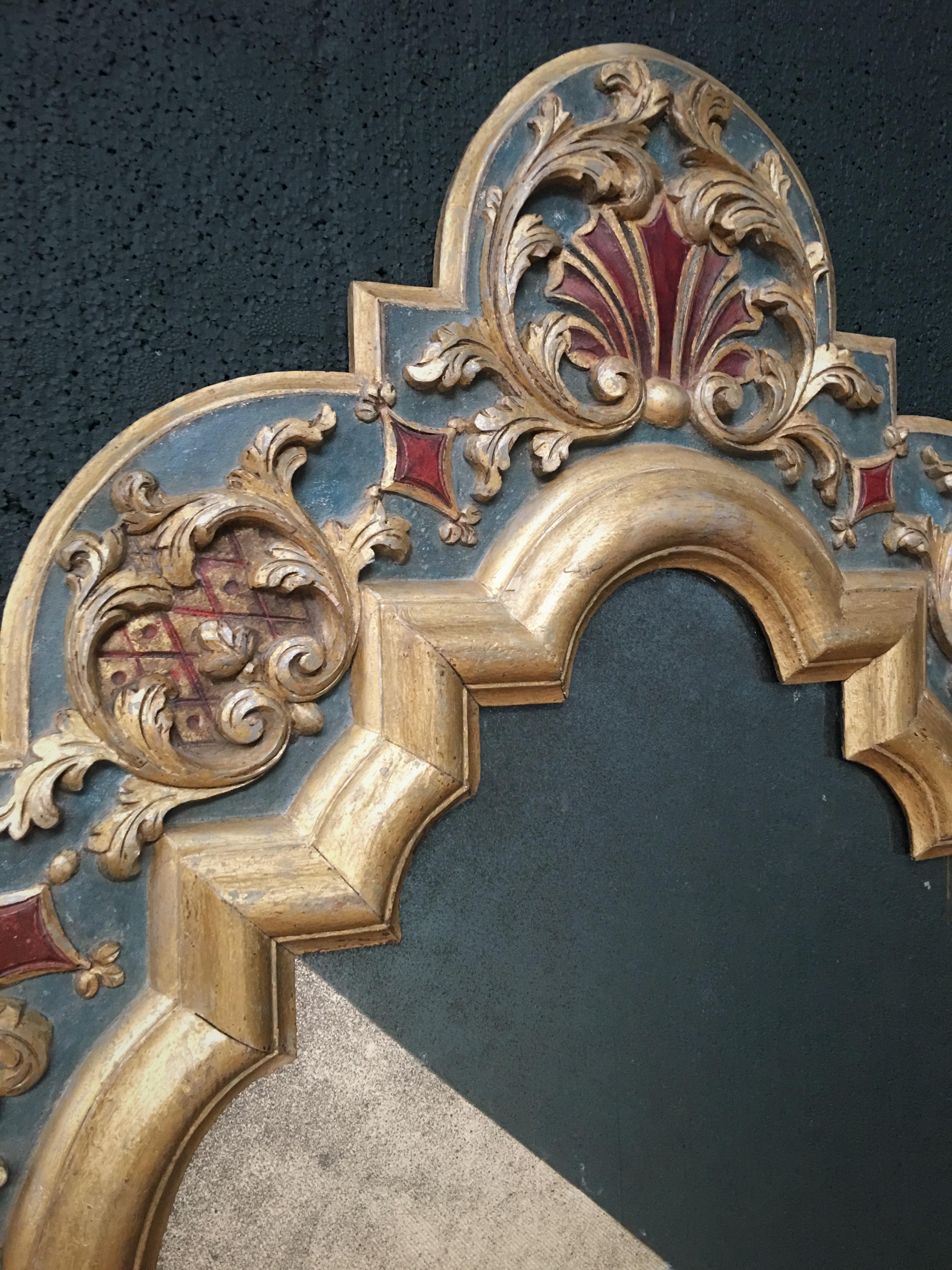 An exceptionally rare, early 19th century carved wood Gothic style mirror, possibly continental. Our restoration team have carefully dry scraped the mirror to remove over-layers, revealing a highly decorative original painted sand-work and oil